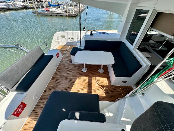 2020 Lagoon 40 catamaran with spacious outdoor seating and dining area by the marina.
