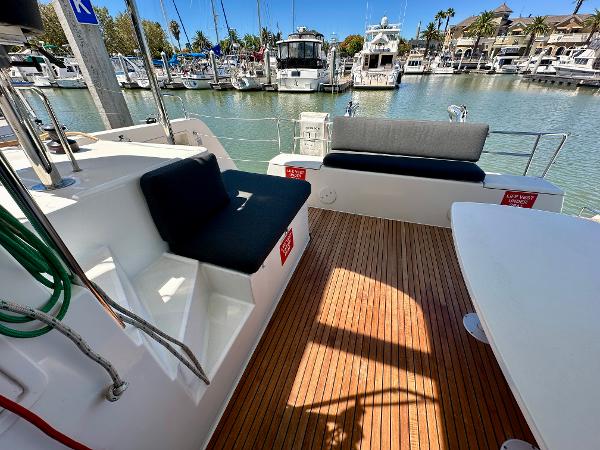2020 Lagoon 40 catamaran deck with seating, docked at marina with yachts.