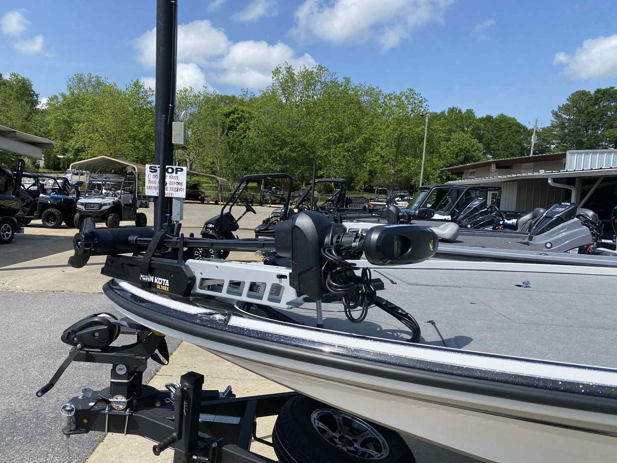2024 Nitro Z20 Pro boat with trolling motor, parked outdoors under a clear sky.