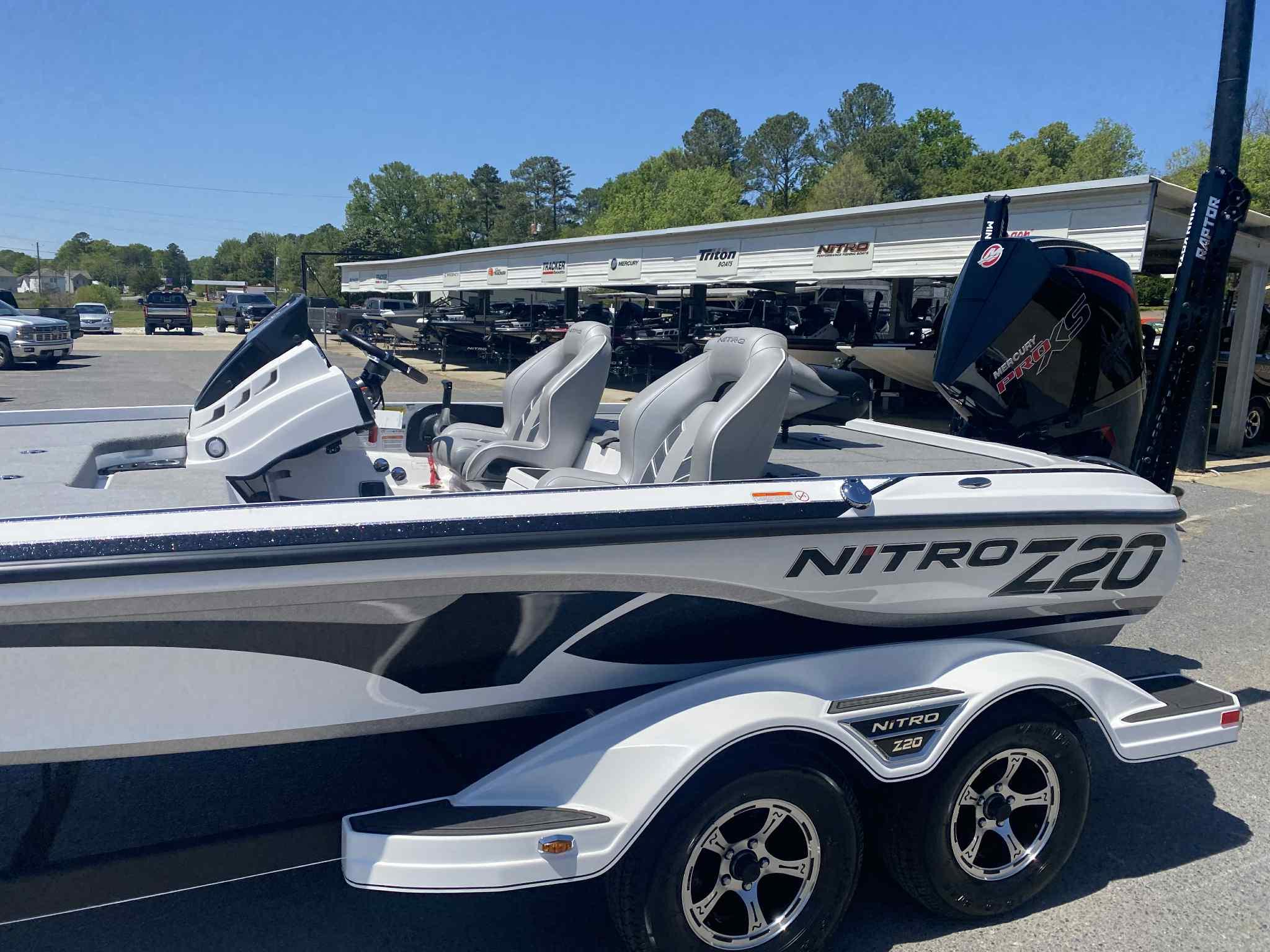 2024 Nitro Z20 Pro boat with dual seats and trailer in a dealership lot.