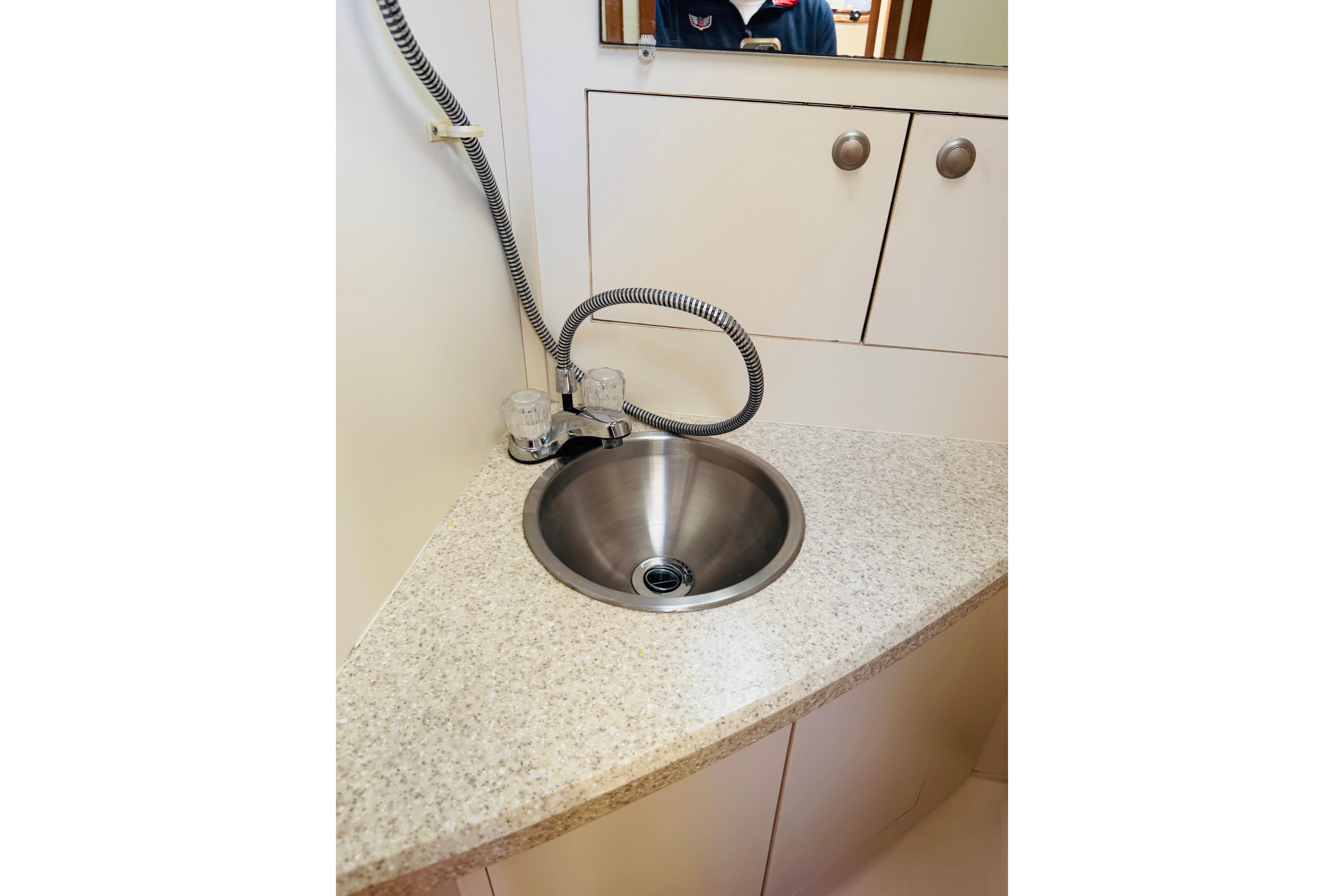 Compact sink area in 2006 Mainship Pilot 30 Sedan boat interior.