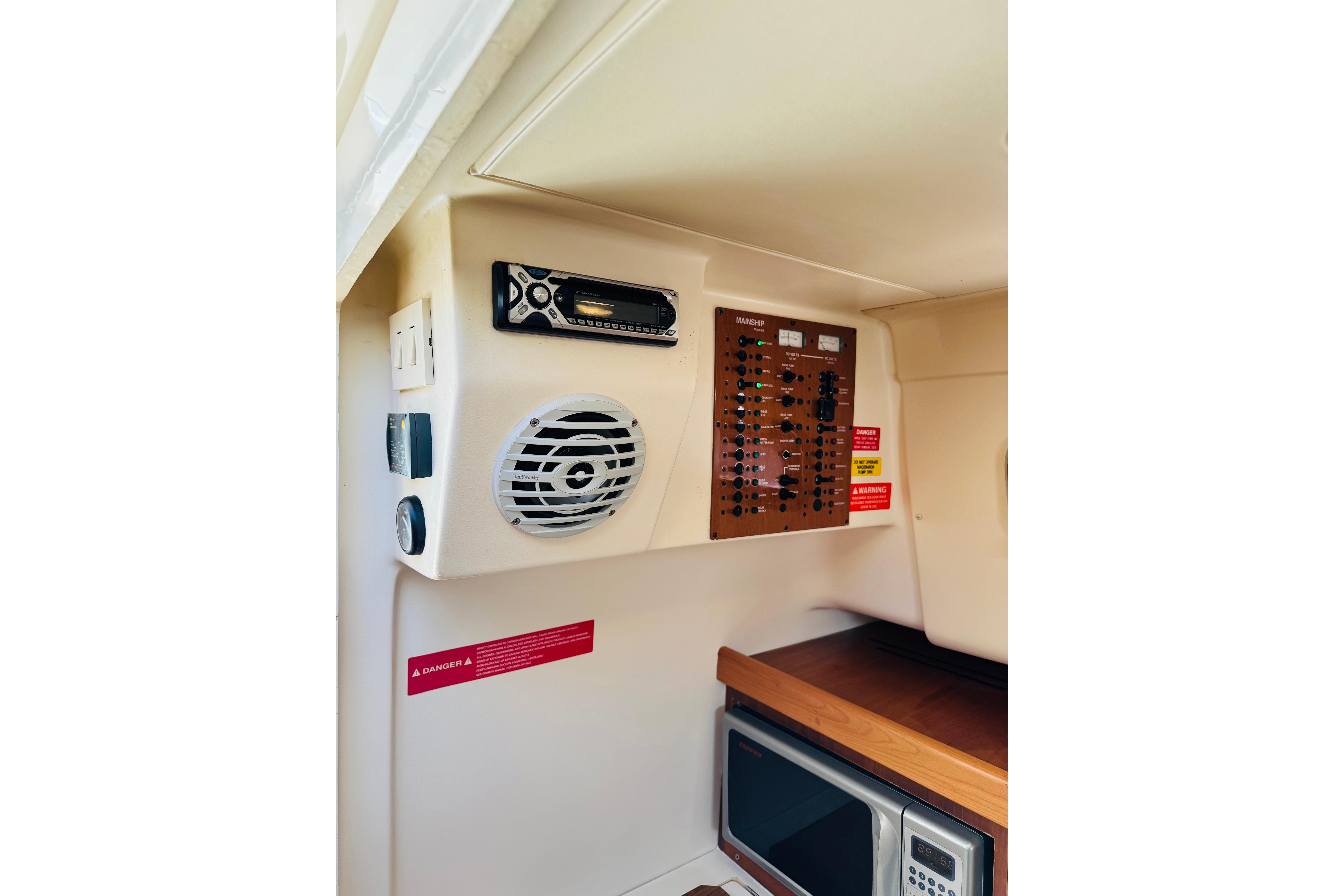 2006 Mainship Pilot 30 Sedan interior with control panel and speaker system.