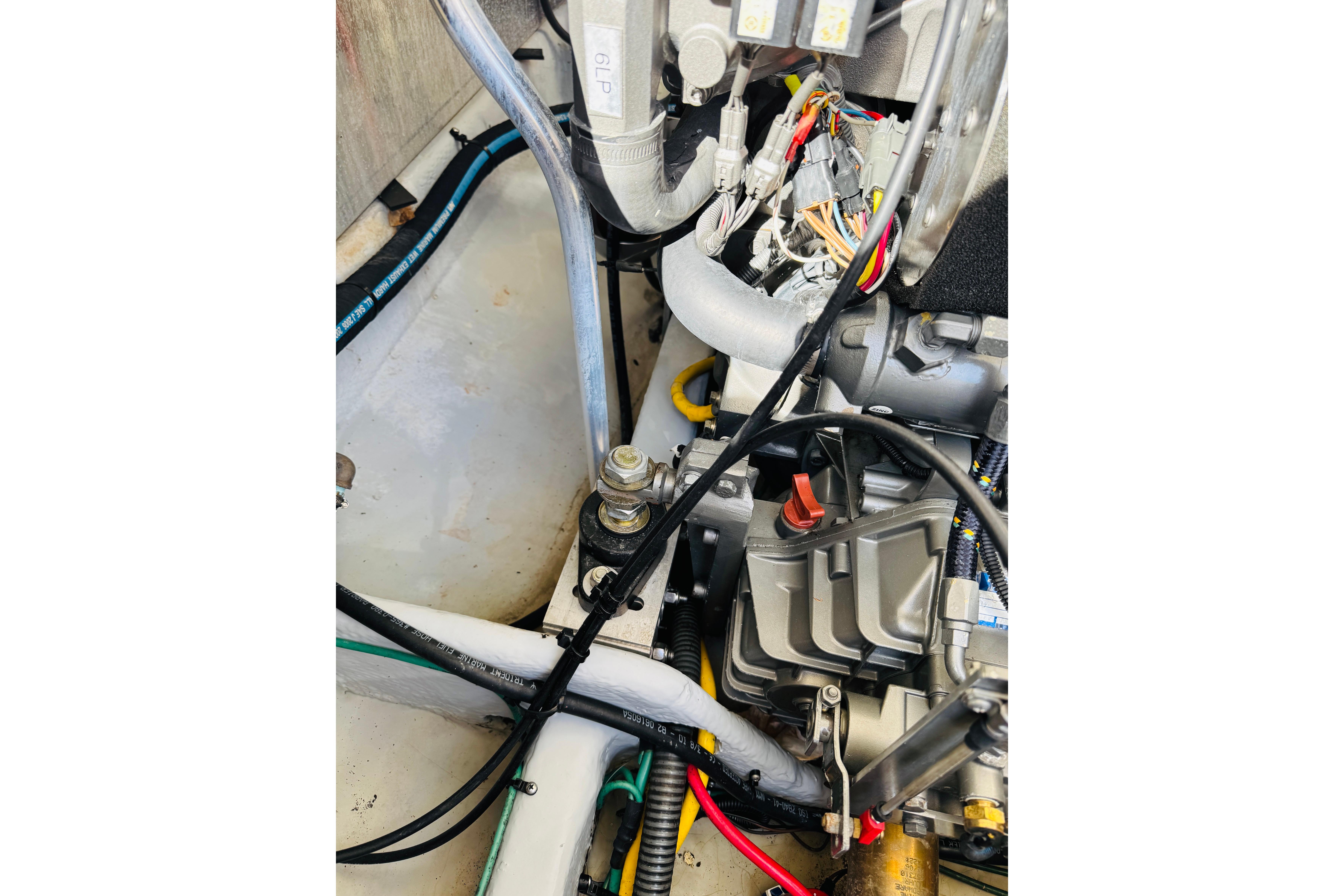 Engine compartment of a 2006 Mainship Pilot 30 Sedan with visible wiring and components.