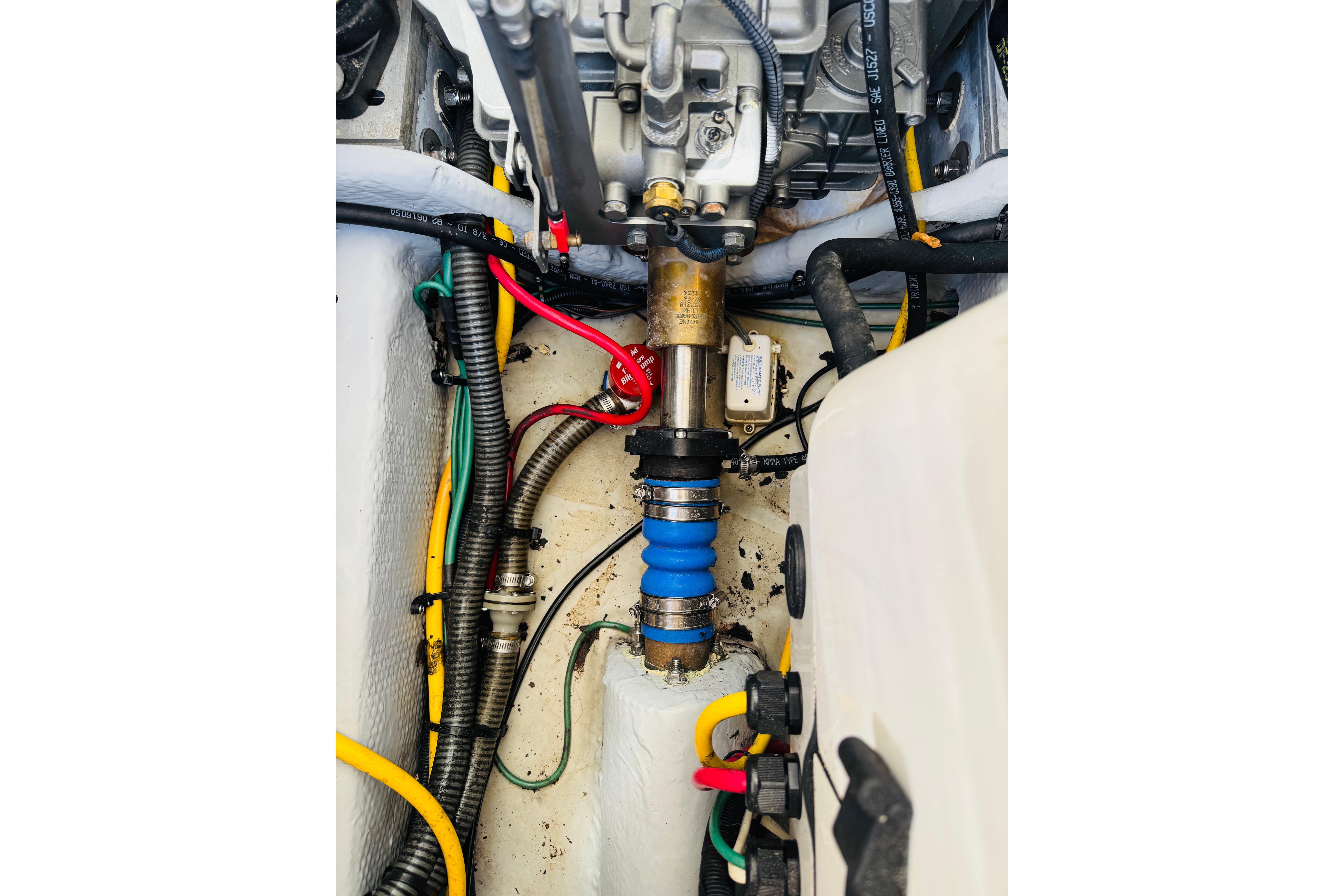 Engine compartment of a 2006 Mainship Pilot 30 Sedan with visible wiring and components.