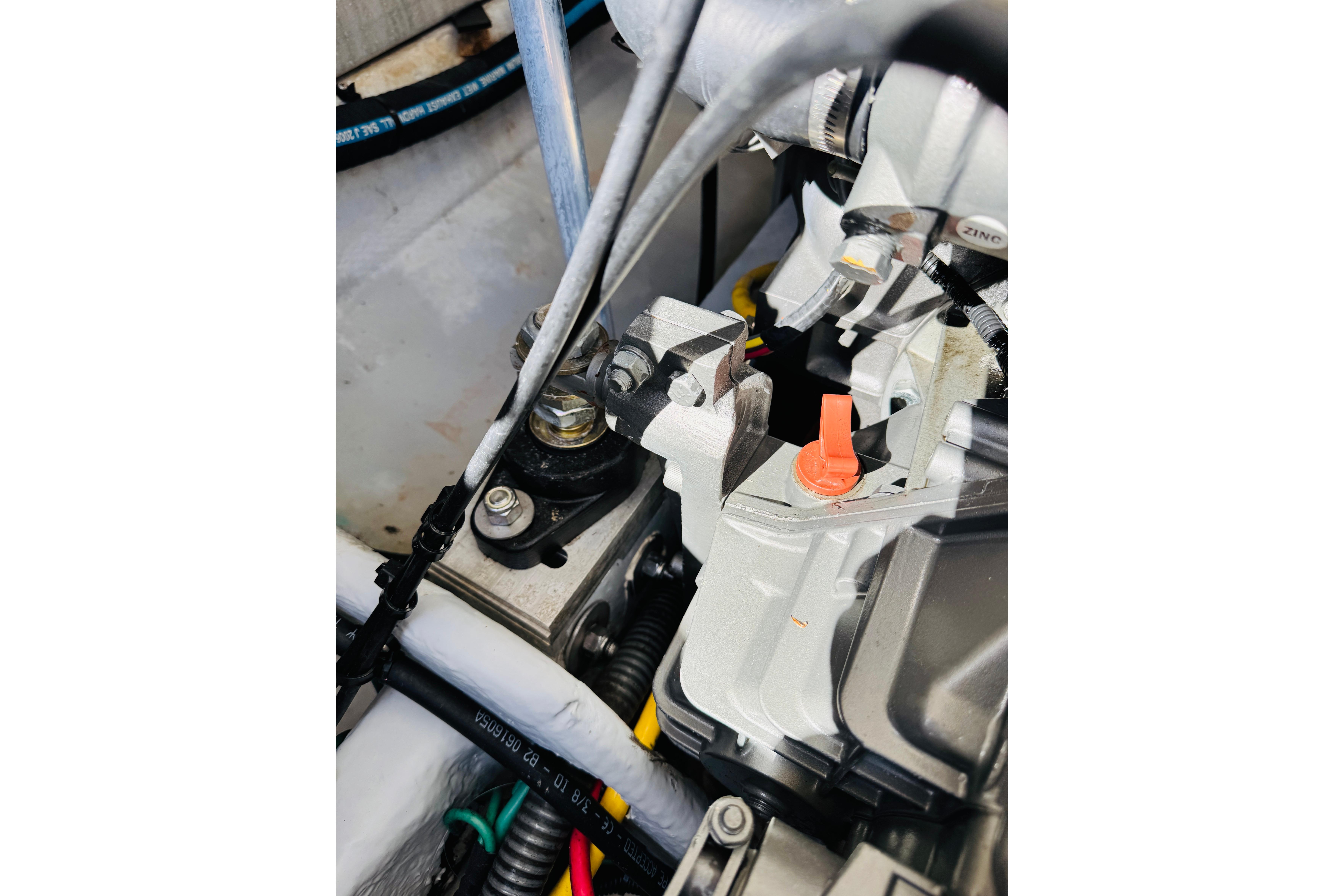 Engine components of a 2006 Mainship Pilot 30 Sedan boat, featuring detailed mechanical parts.