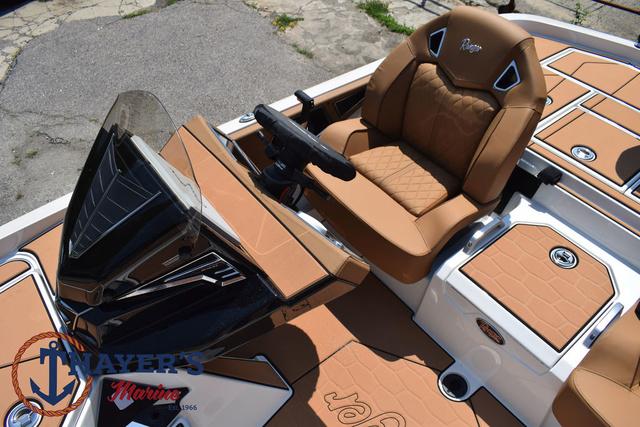 2025 Ranger Z520R Cup-Equipped boat interior with tan leather seating and steering console.