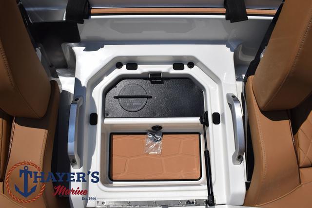2025 Ranger Z520R Cup-Equipped boat interior storage compartment with tan seats.