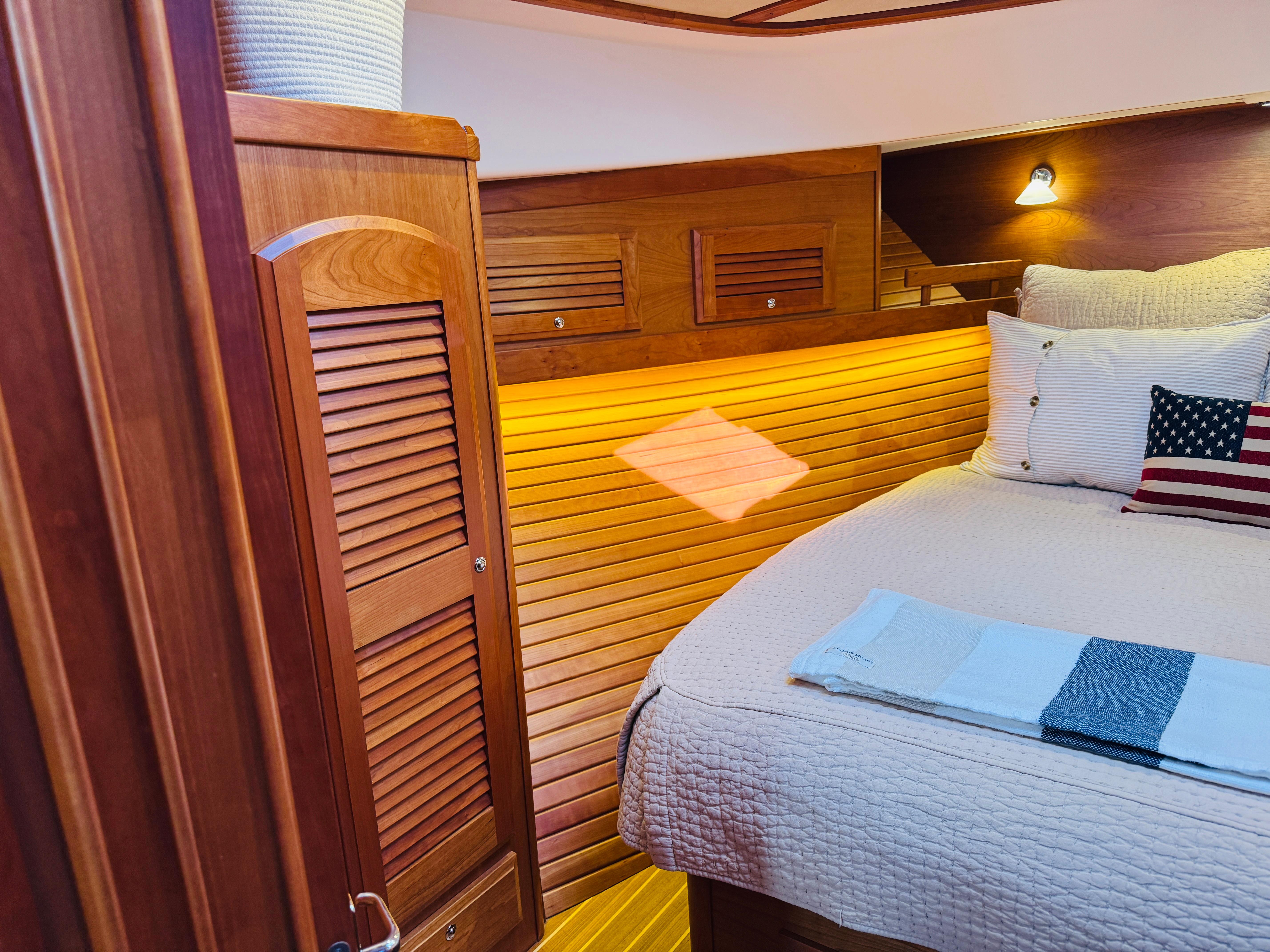 Cozy cabin interior of 2018 Sabre 42 Salon Express with wooden accents and soft lighting.