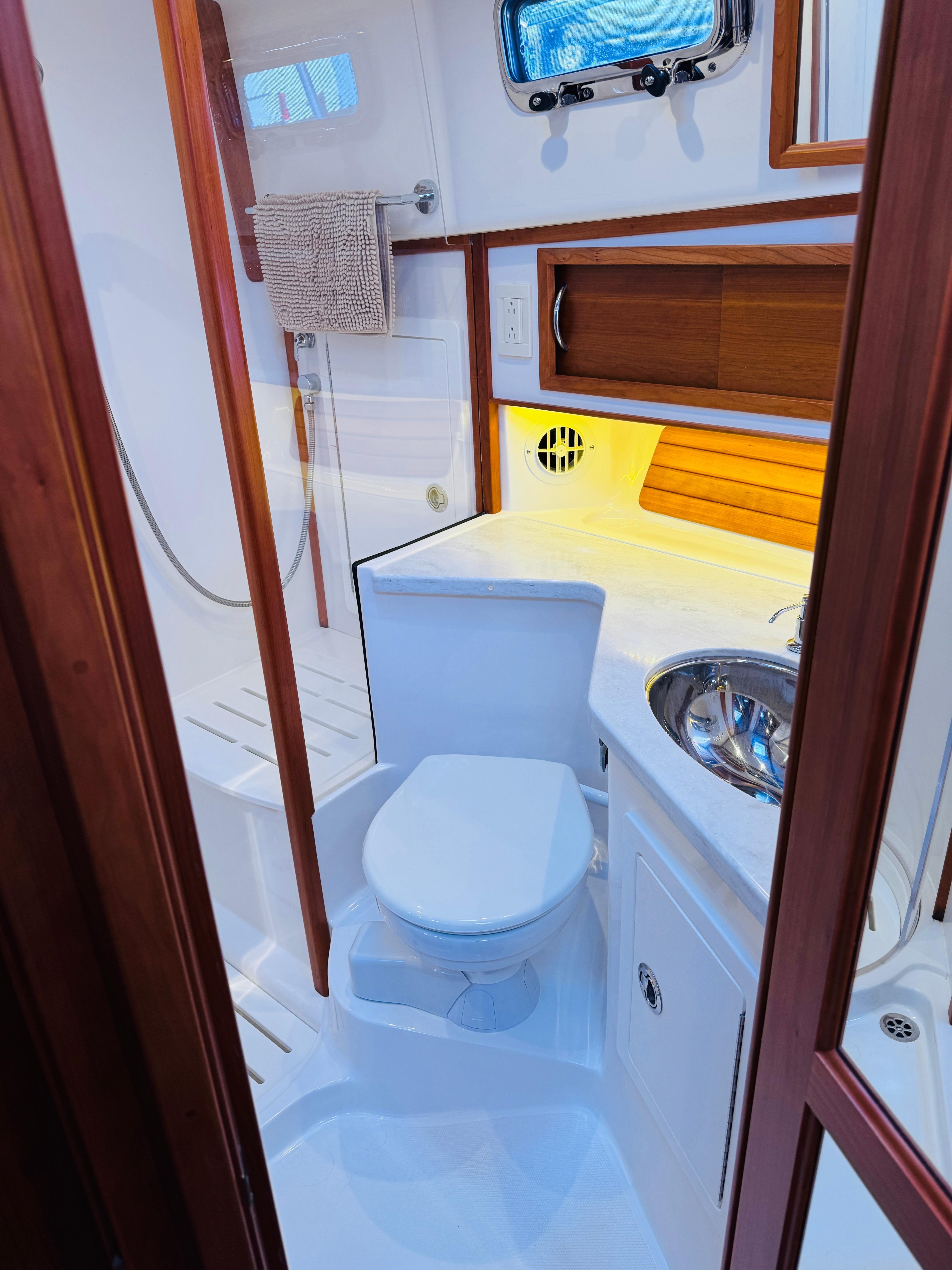 2018 Sabre 42 Salon Express bathroom with modern fixtures and wooden accents.