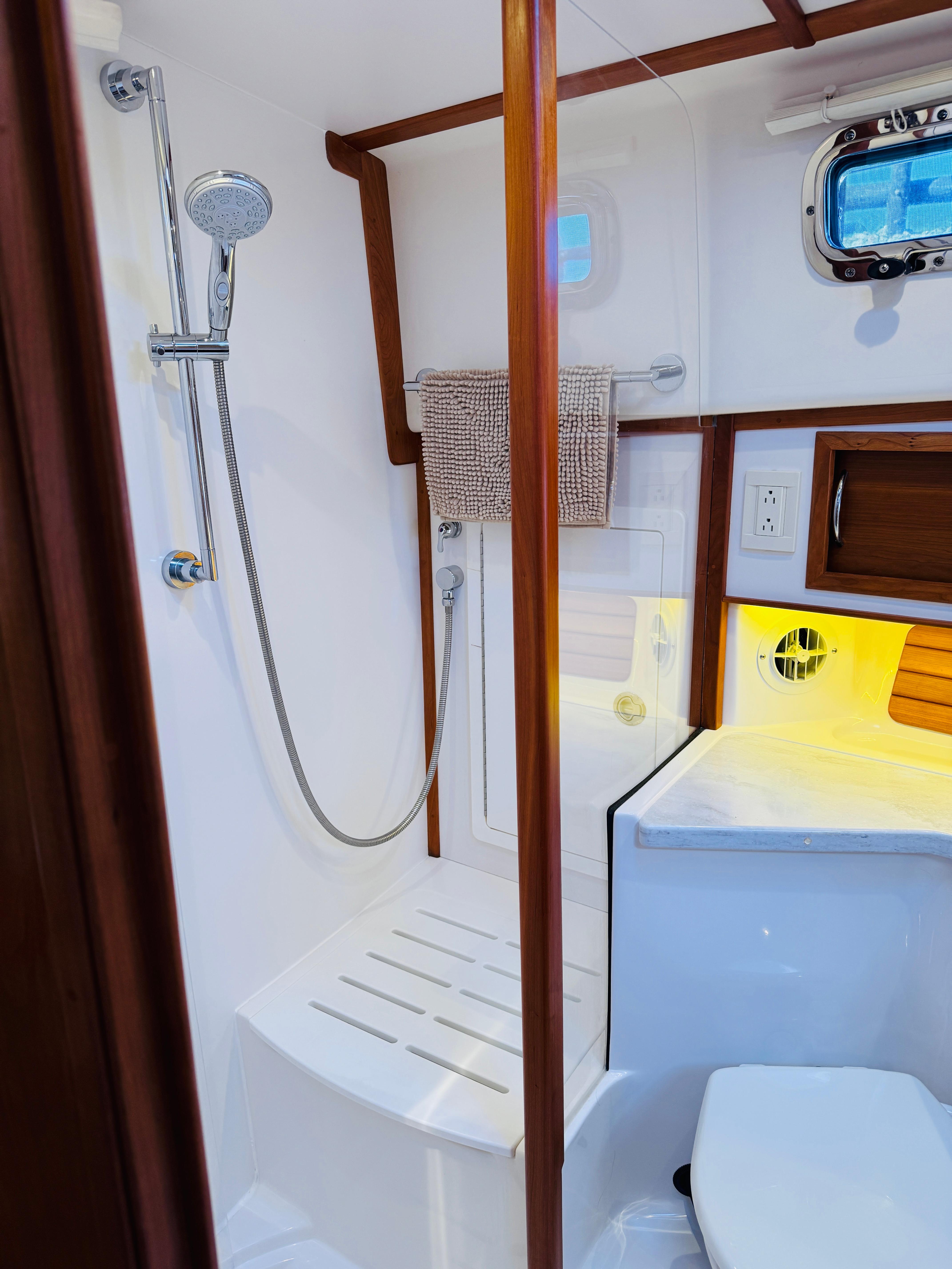 2018 Sabre 42 Salon Express bathroom with shower, wooden accents, and modern fixtures.