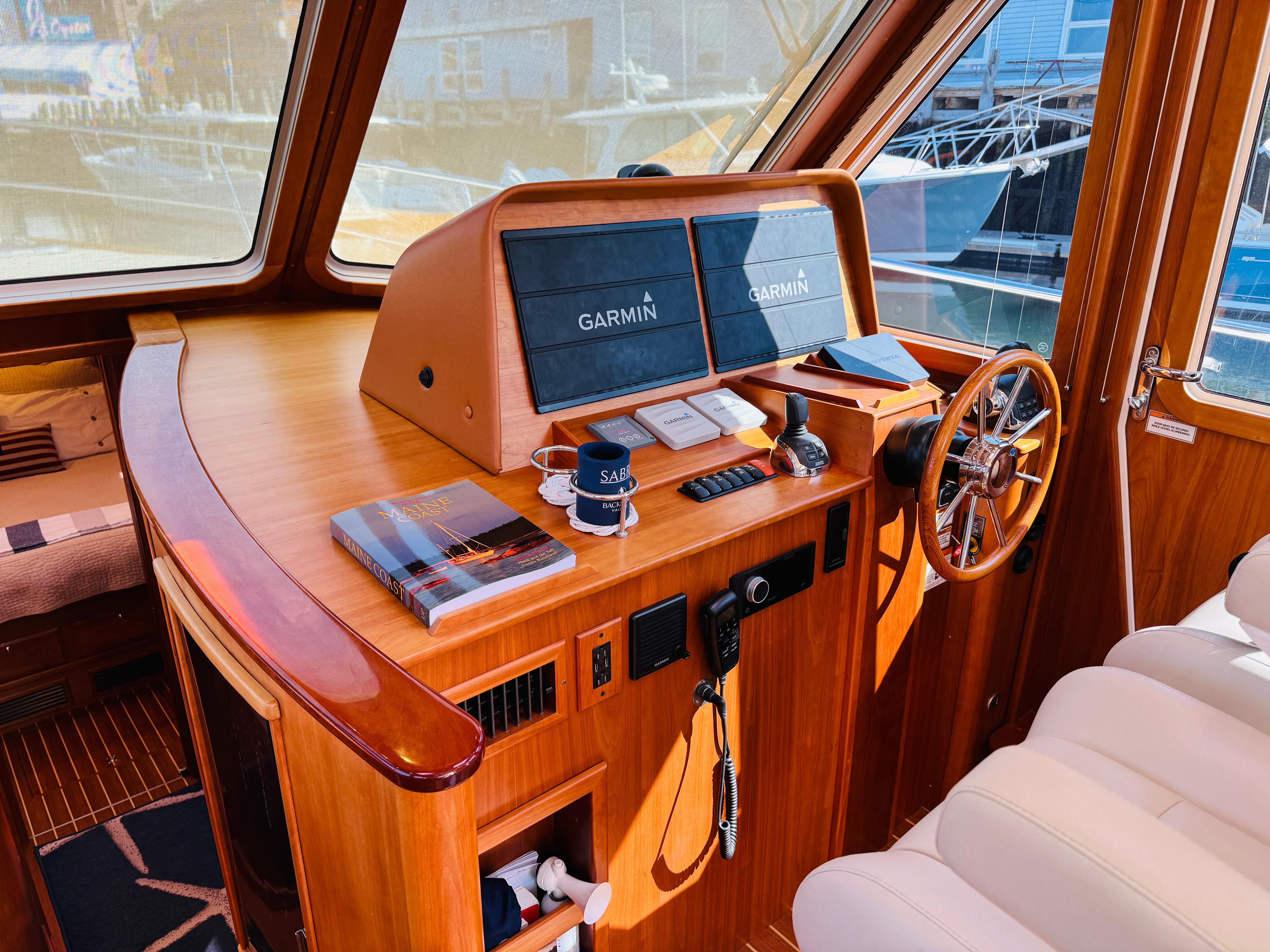 2018 Sabre 42 Salon Express helm with Garmin displays and wooden interior.