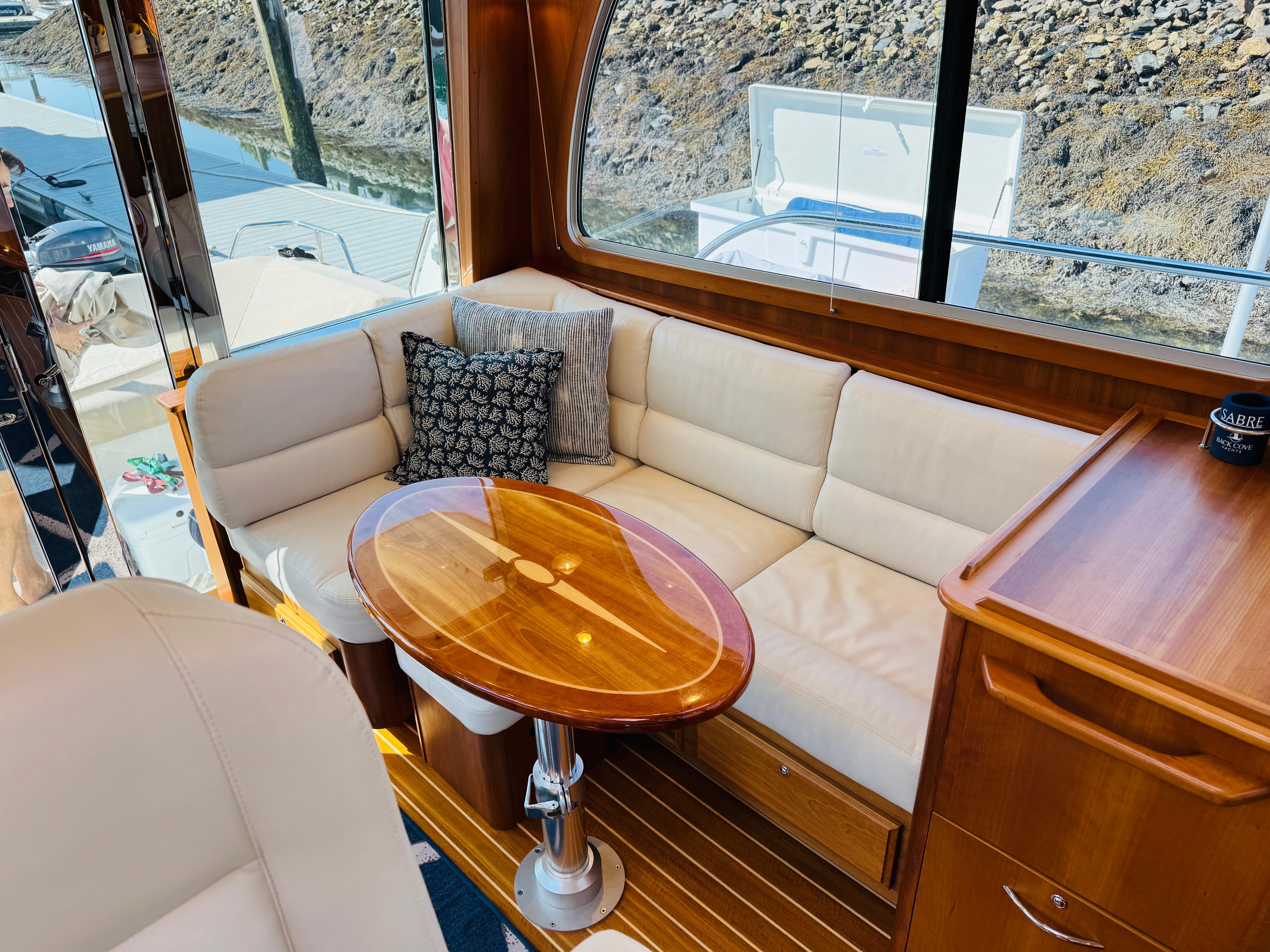 Luxurious interior of 2018 Sabre 42 Salon Express yacht with elegant seating and wooden table.