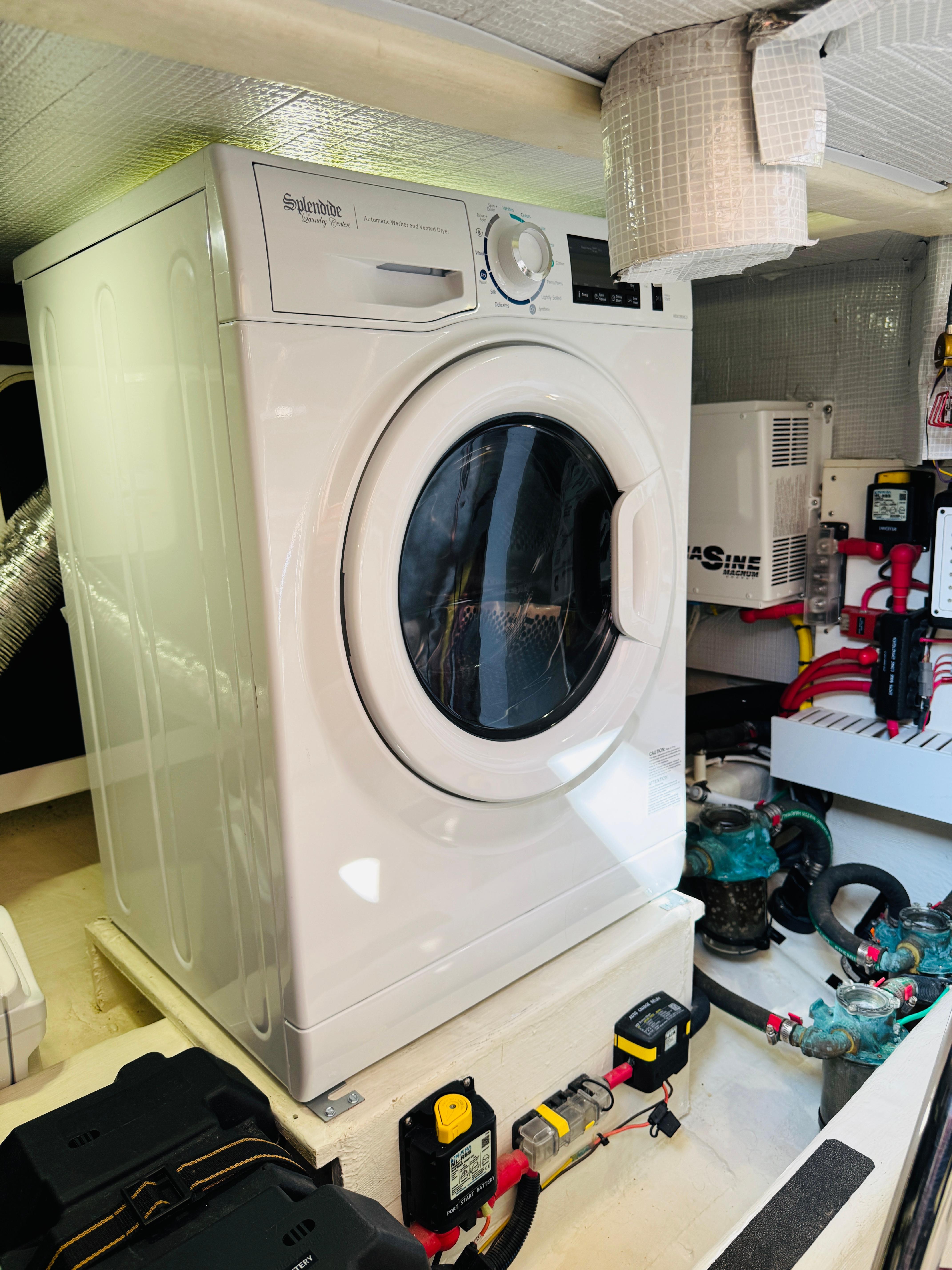 Laundry area inside 2018 Sabre 42 Salon Express yacht, featuring a washing machine.