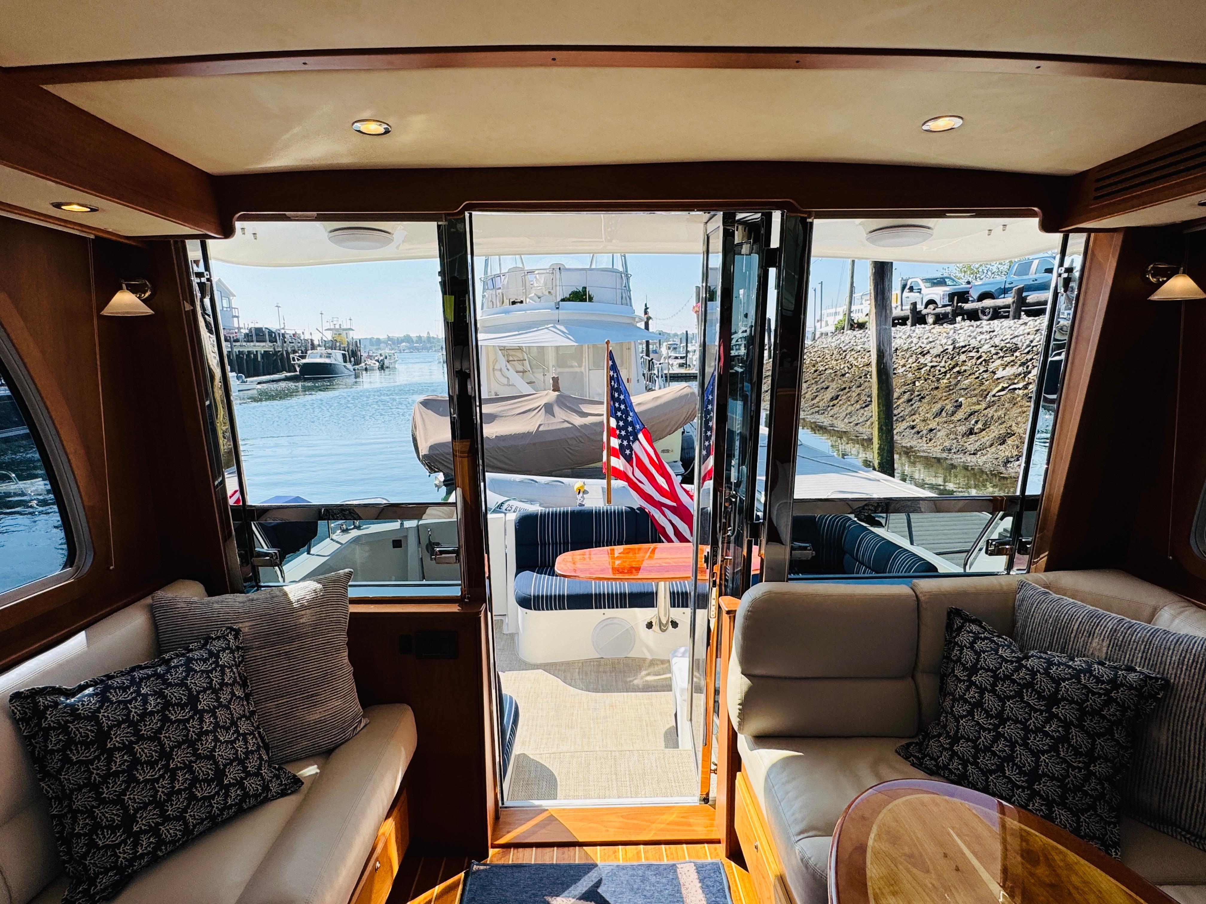 Interior view of 2018 Sabre 42 Salon Express yacht with American flag and waterfront.