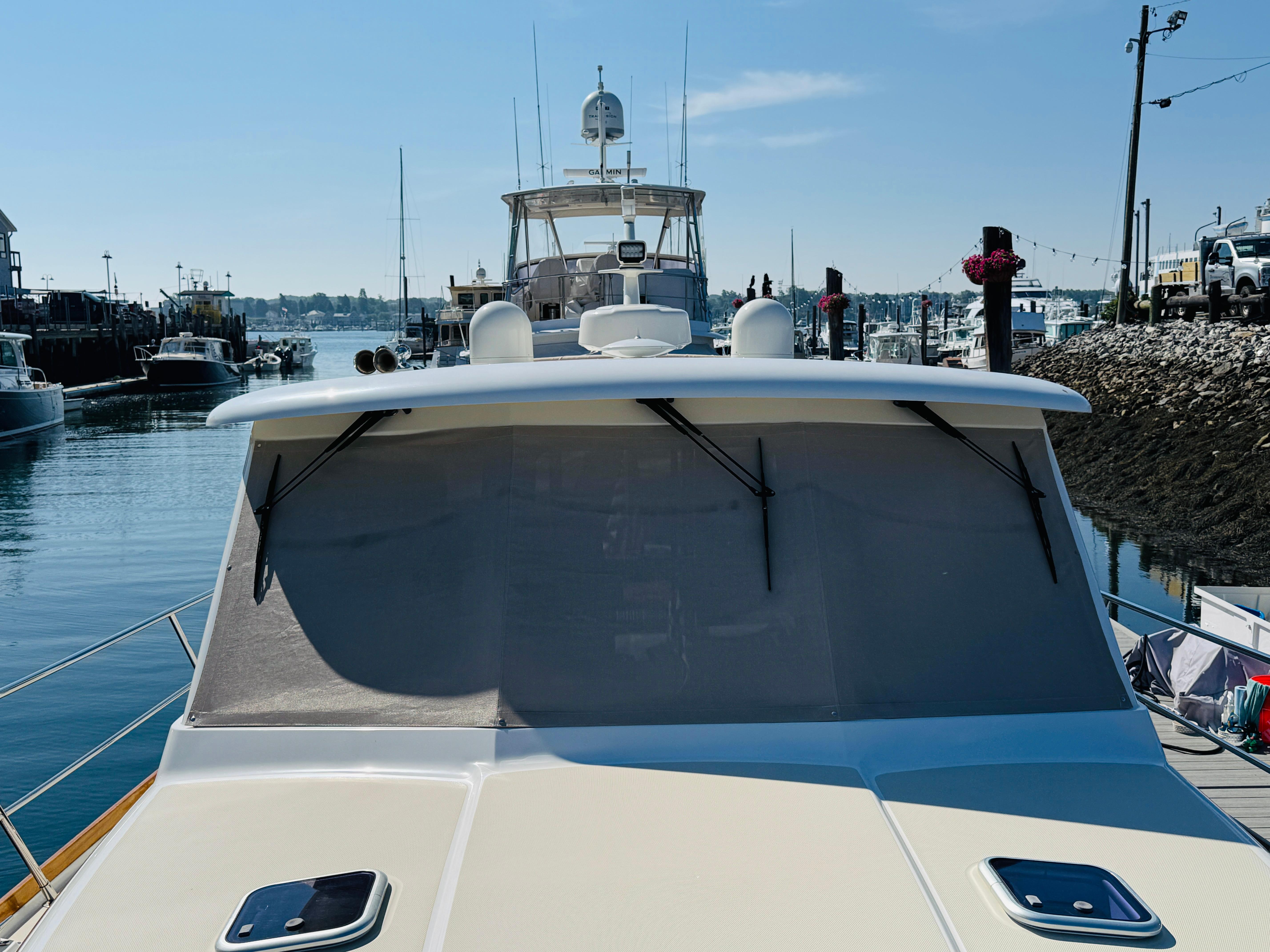 2018 Sabre 42 Salon Express yacht docked in a marina under clear skies.