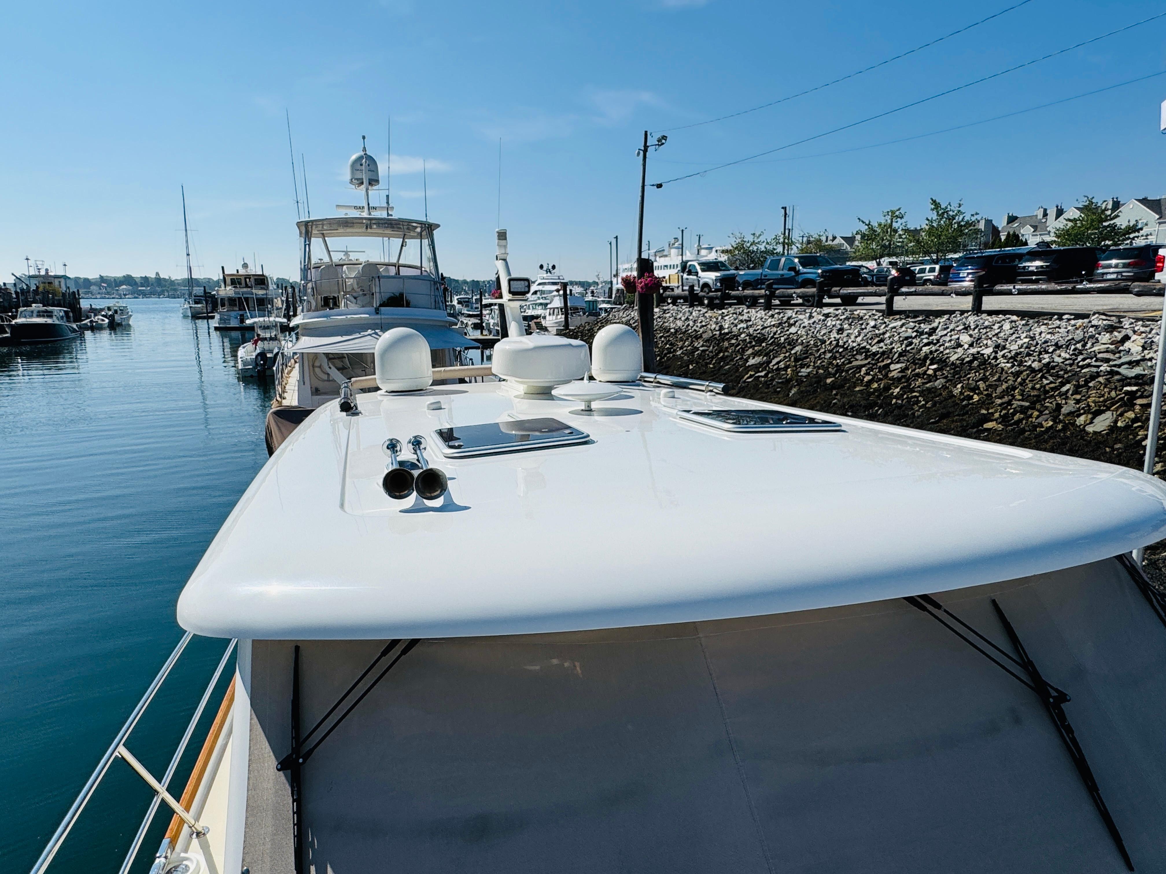 2018 Sabre 42 Salon Express yacht docked at a marina under clear blue skies.