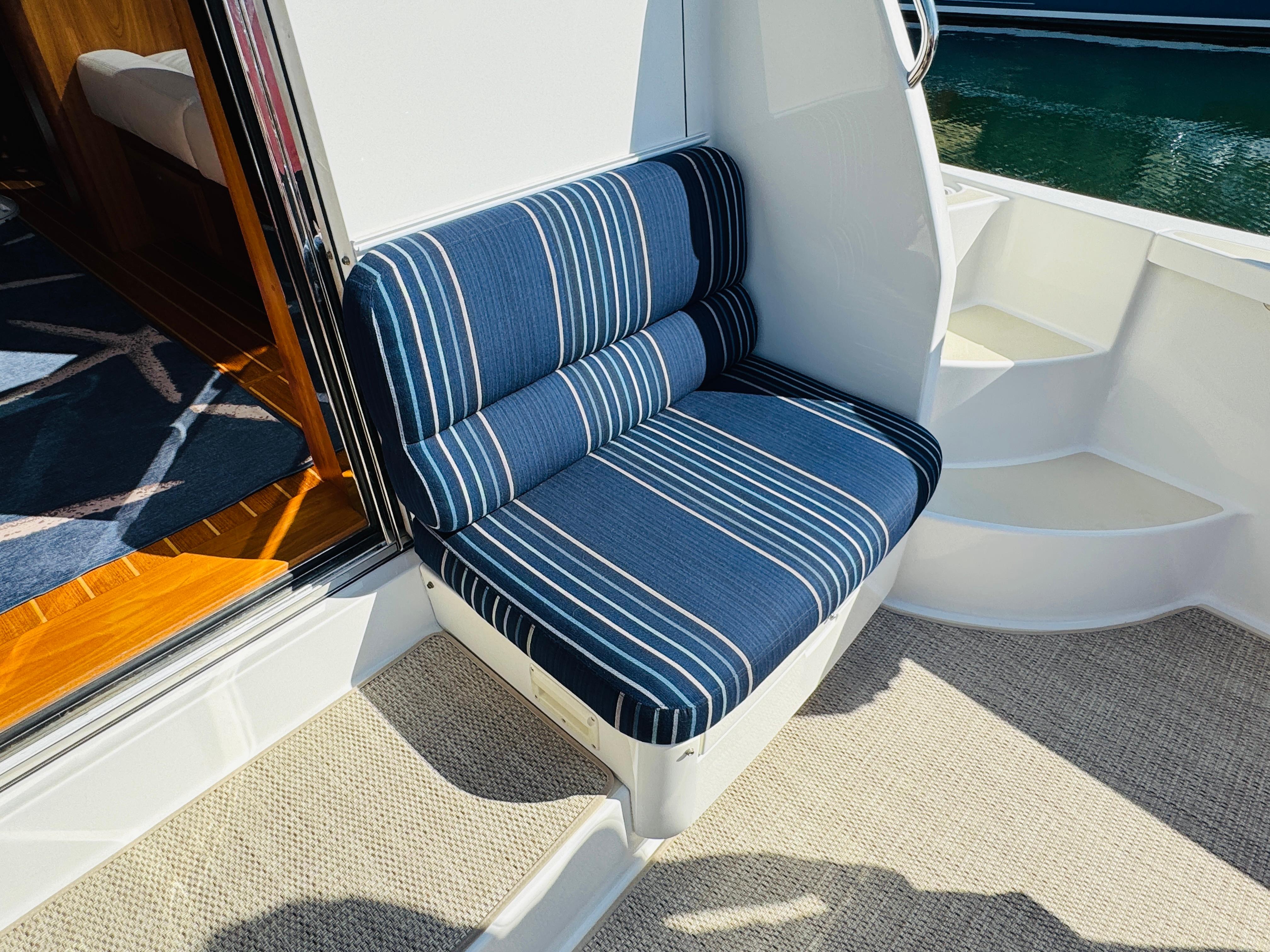 Blue striped seating on 2018 Sabre 42 Salon Express yacht, near cabin entrance.