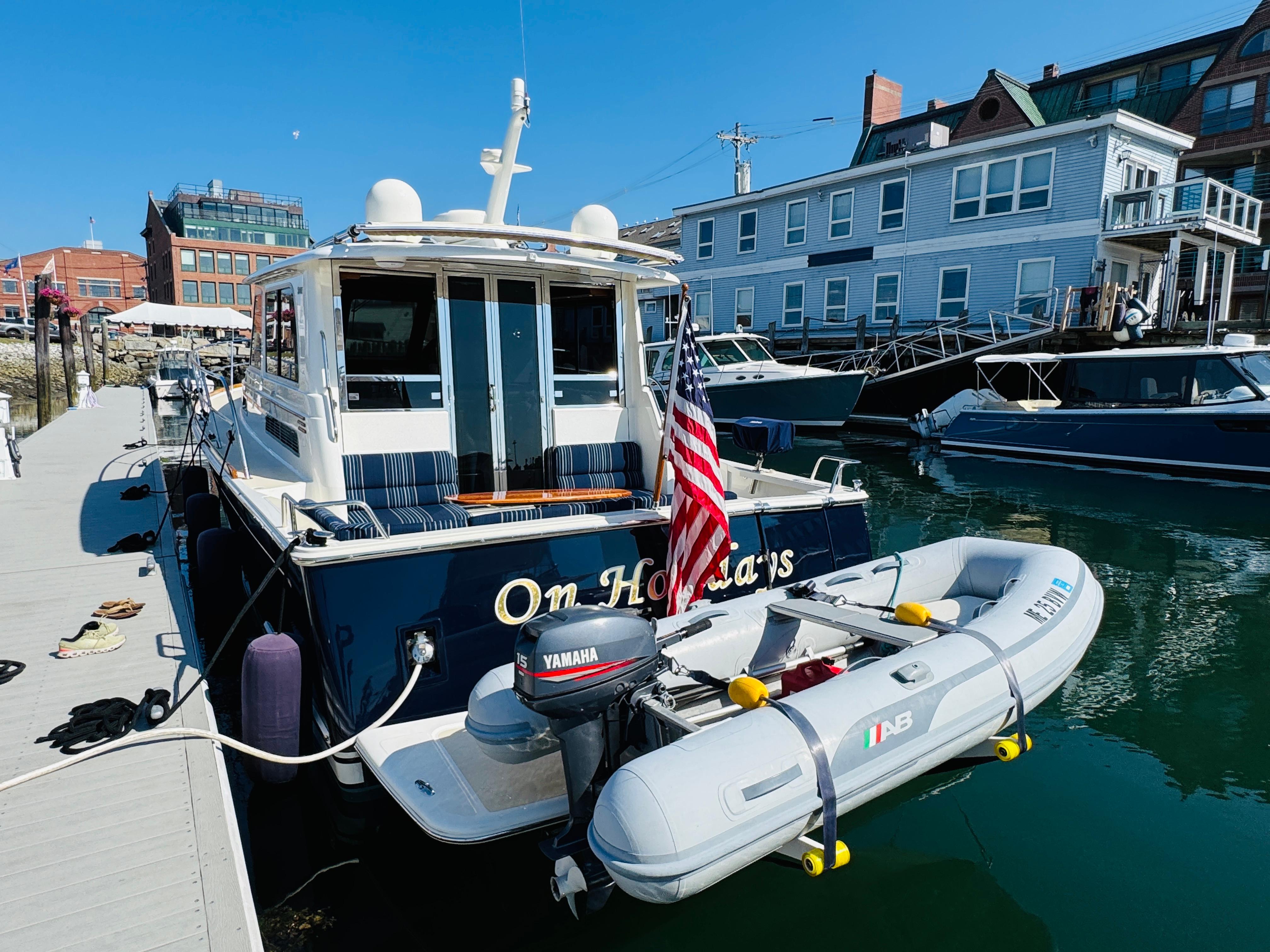 2018 Sabre 42 Salon Express yacht docked with inflatable boat and American flag.