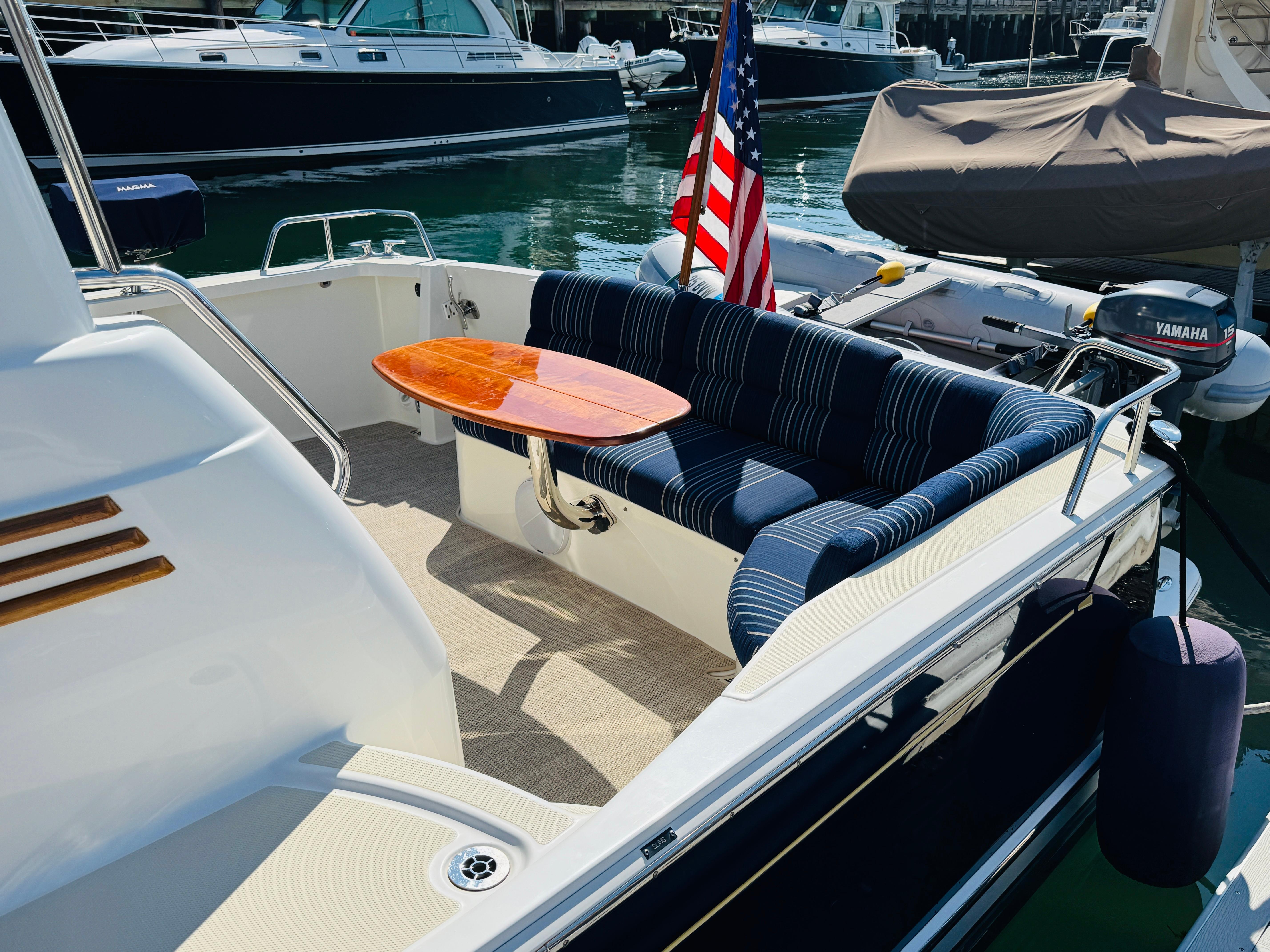 2018 Sabre 42 Salon Express yacht with elegant seating and table, docked in a marina.
