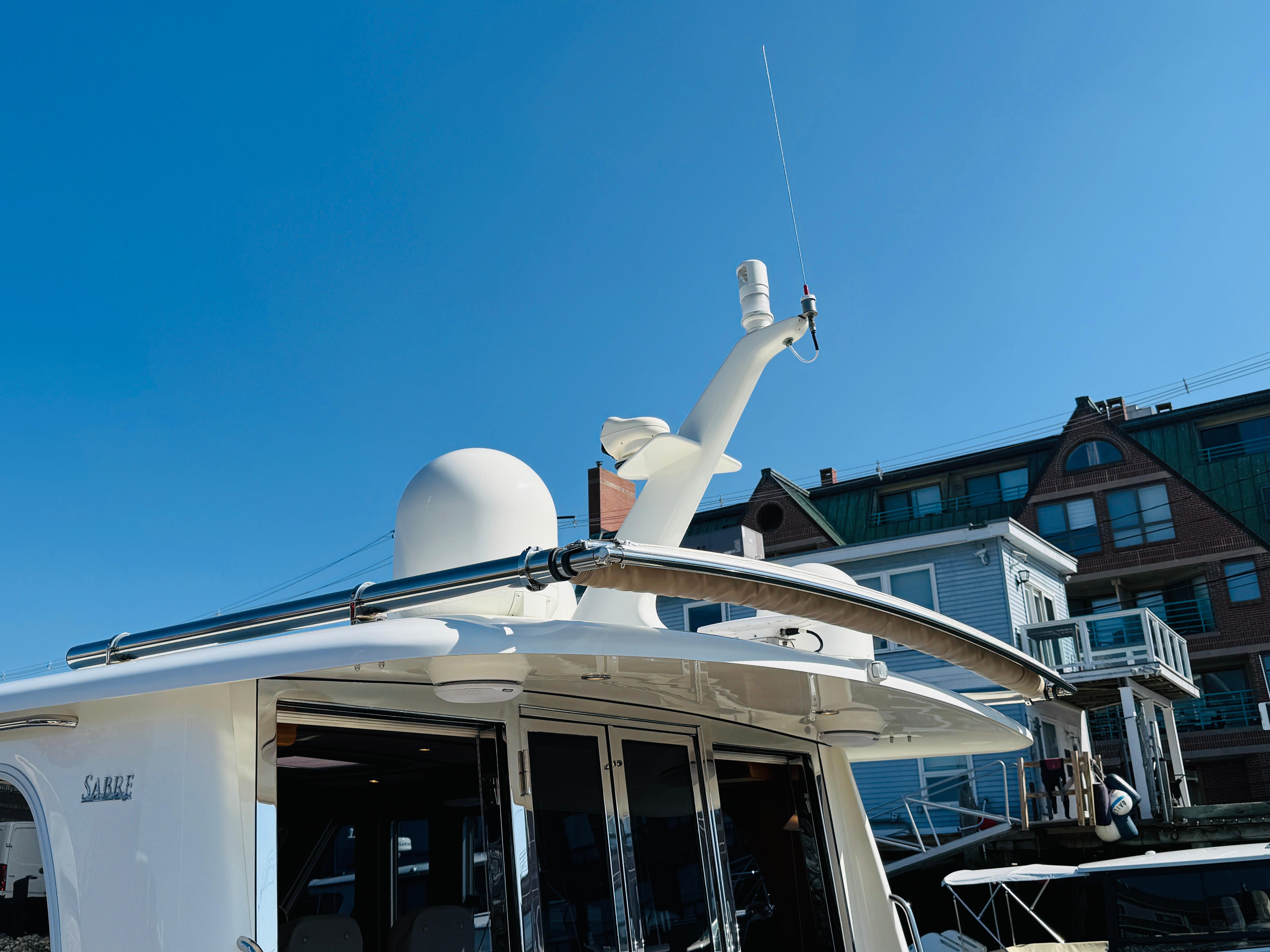 2018 Sabre 42 Salon Express yacht docked, showcasing radar and antenna against a clear blue sky.