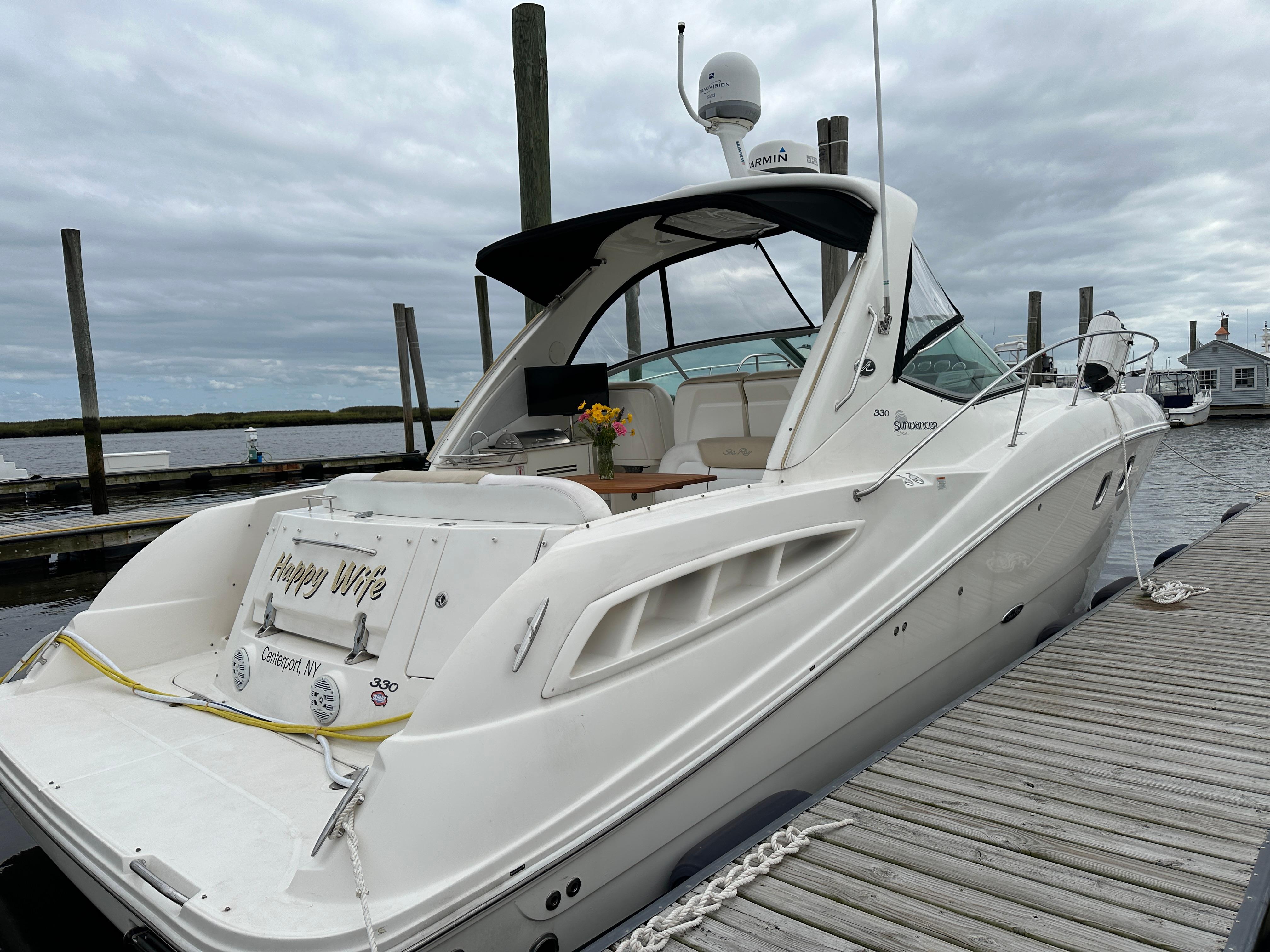 2008 Sea Ray 330 Sundancer docked, featuring sleek design and spacious deck.