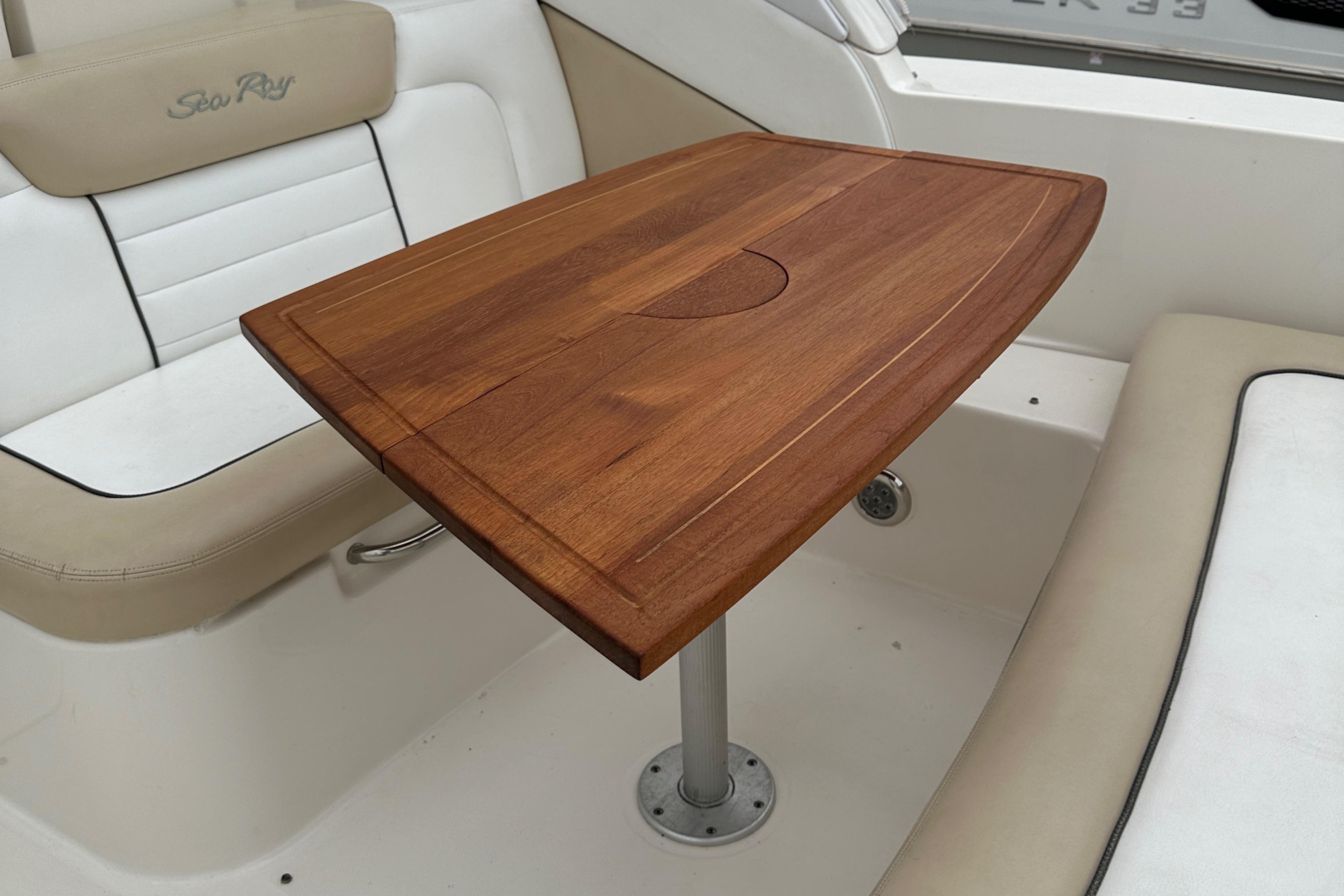Teak table on 2008 Sea Ray 330 Sundancer boat interior.