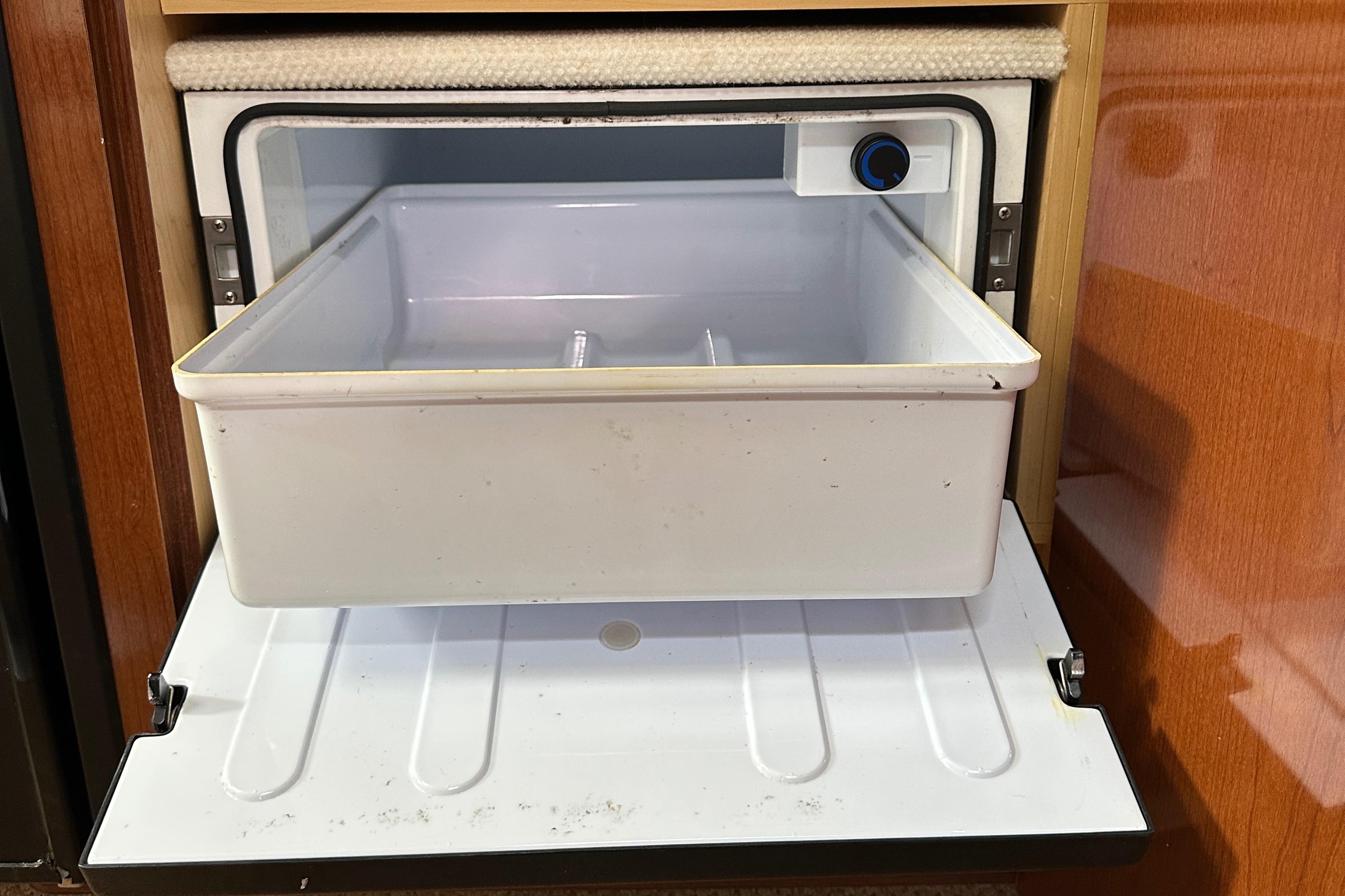 Open refrigerator drawer in 2008 Sea Ray 330 Sundancer boat interior.