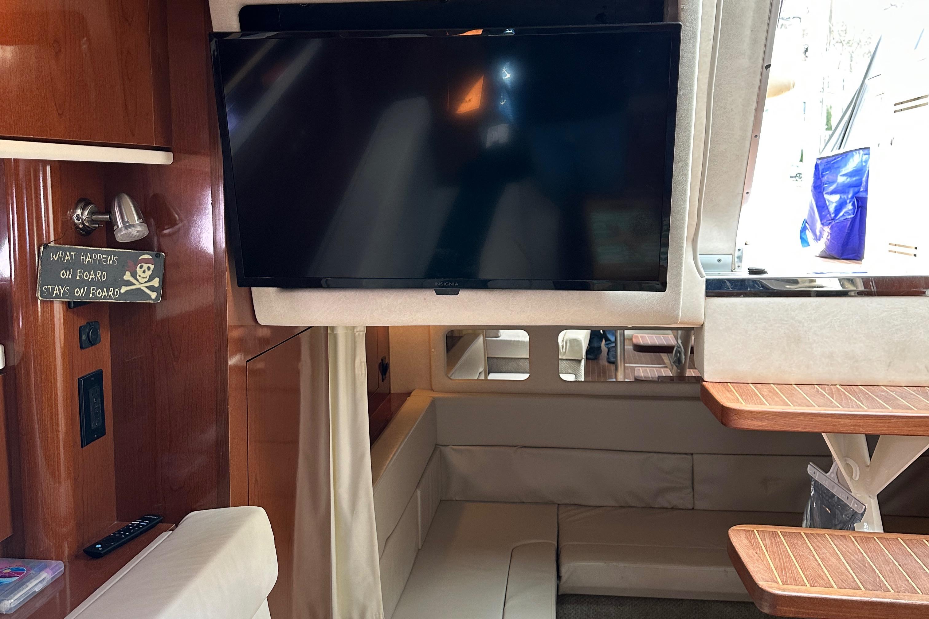 Interior of 2008 Sea Ray 330 Sundancer with TV and seating area.