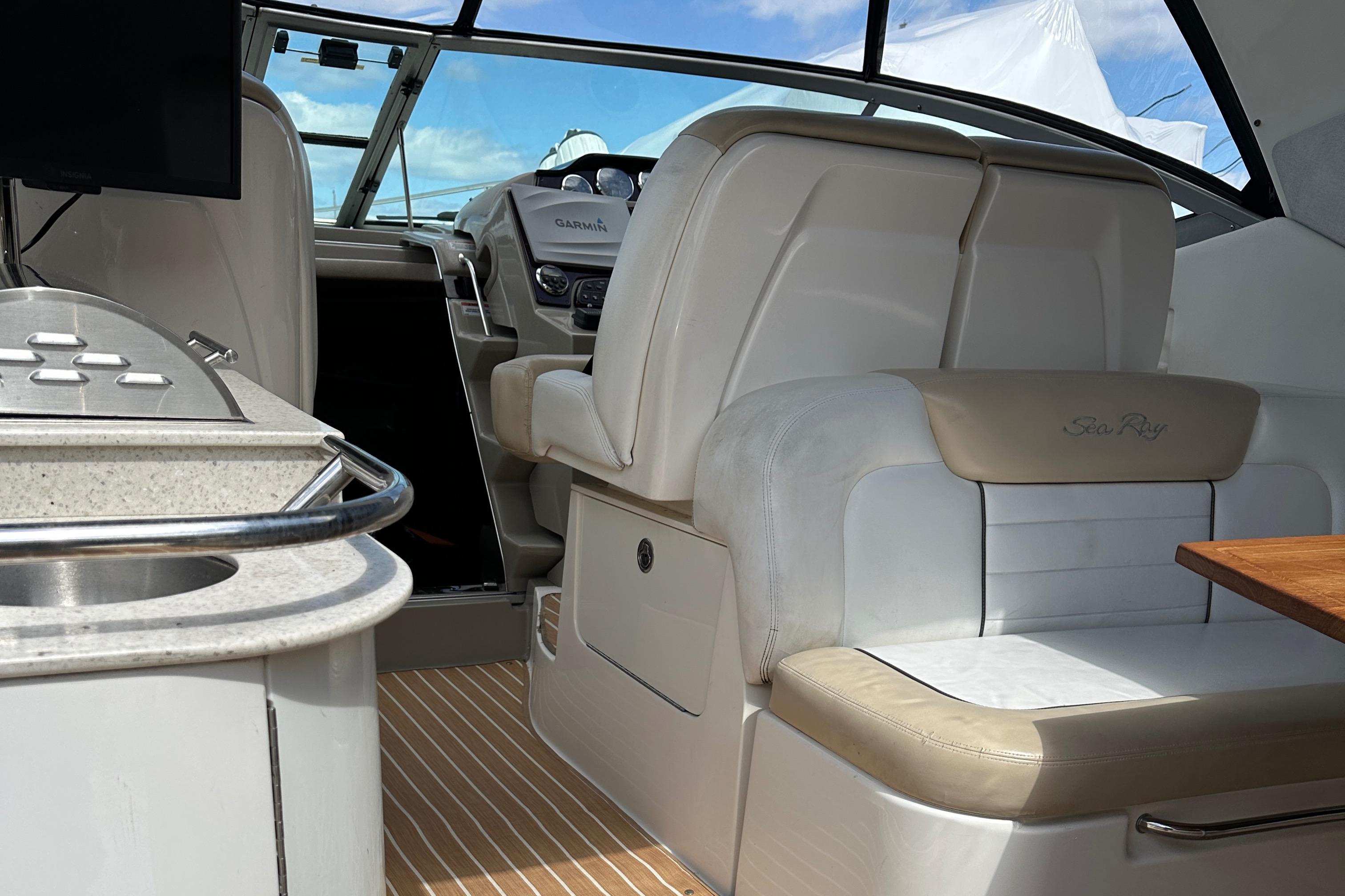 Interior of 2008 Sea Ray 330 Sundancer boat with luxurious seating and modern dashboard.