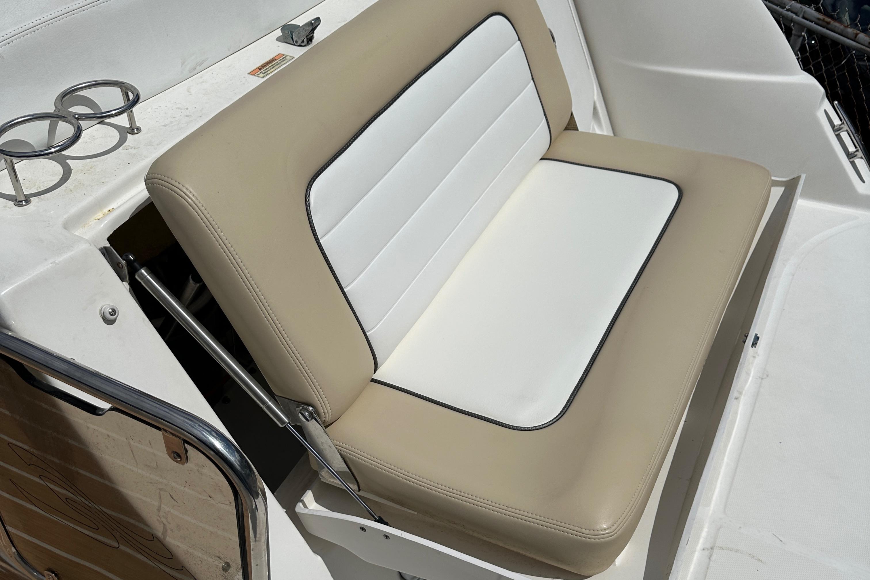 2008 Sea Ray 330 Sundancer boat seat with beige and white upholstery.