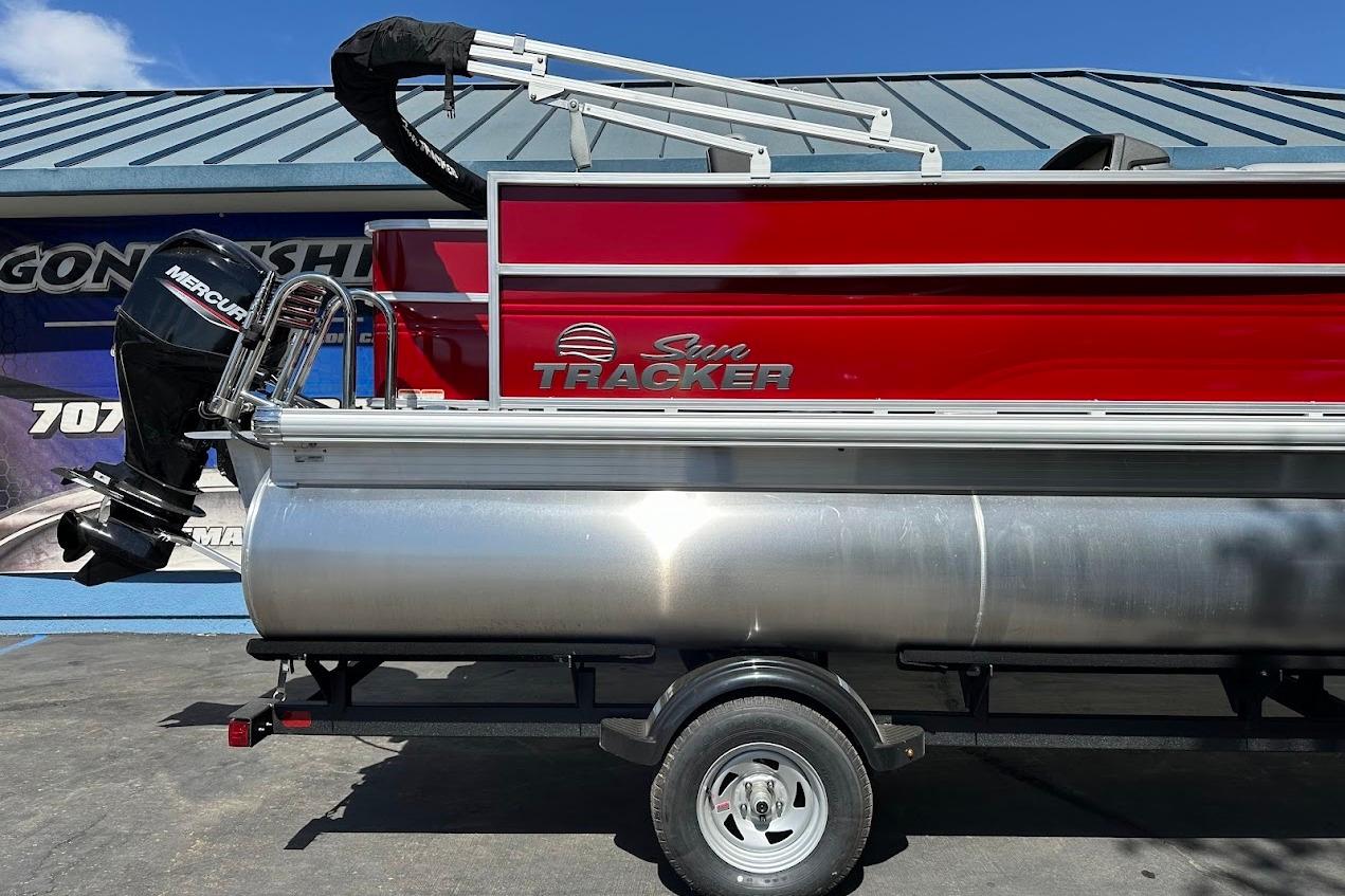 2026 Sun Tracker Party Barge 18 DLX pontoon boat with Mercury outboard motor.
