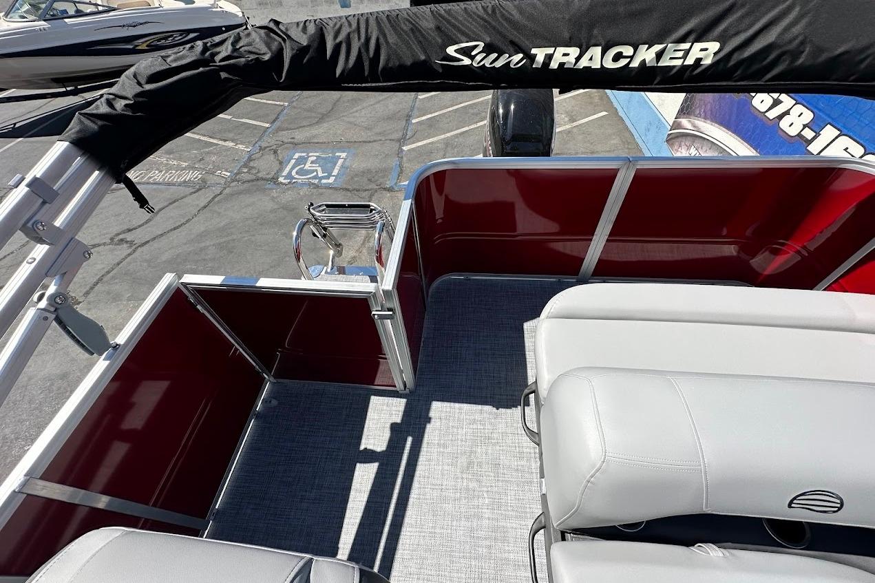 2026 Sun Tracker Party Barge 18 DLX interior with seating and deck view.
