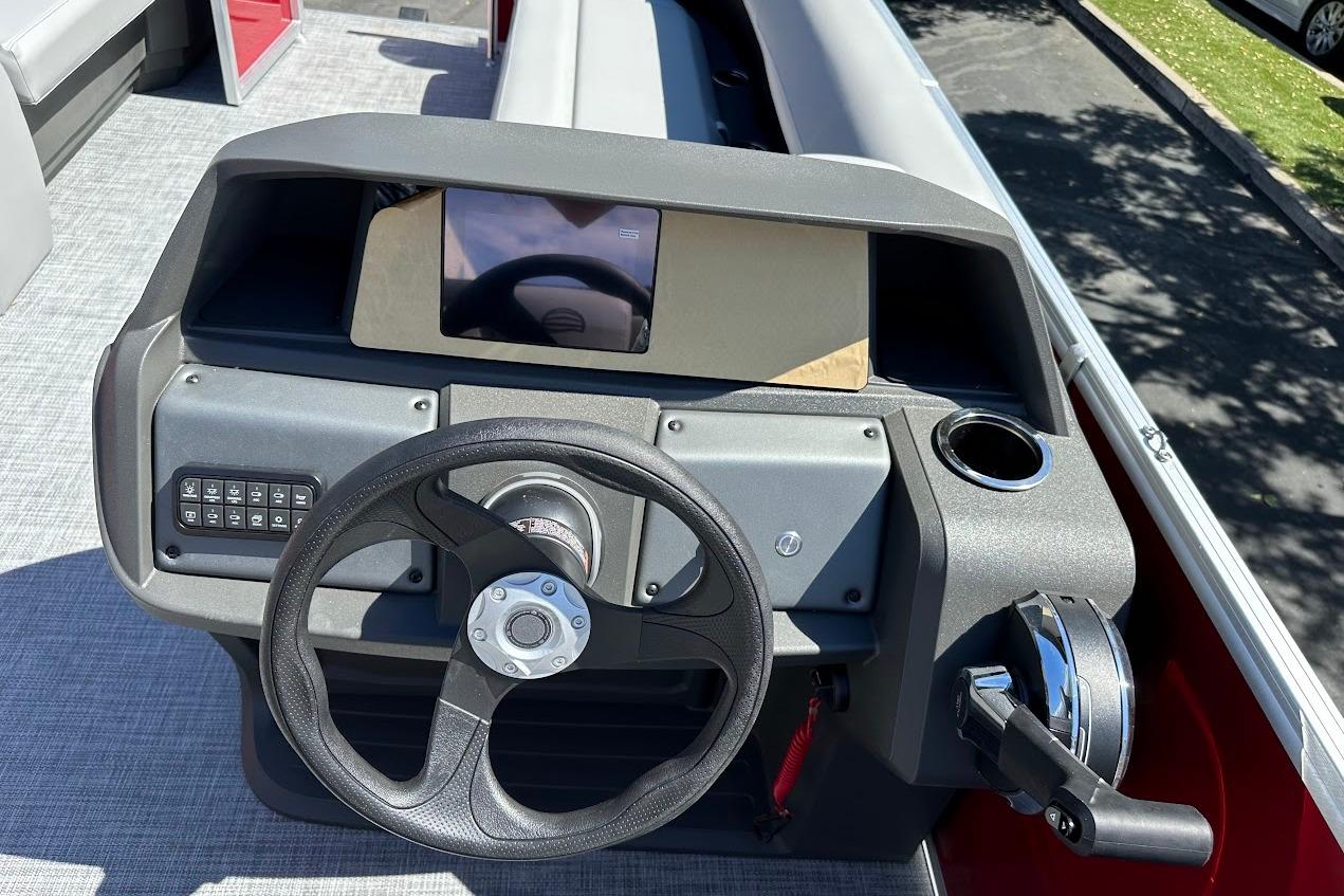 2026 Sun Tracker Party Barge 18 DLX dashboard with steering wheel and control panel.