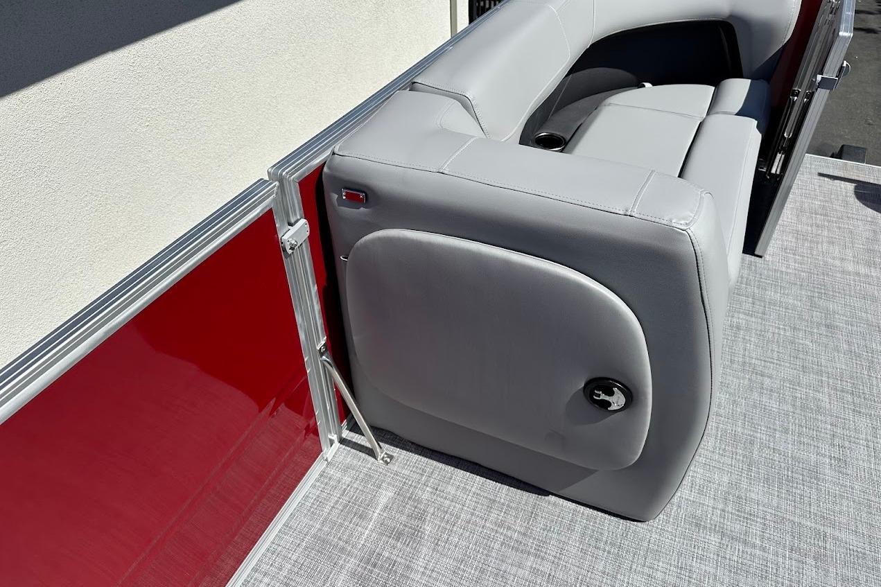 2026 Sun Tracker Party Barge 18 DLX with gray seating and red paneling.