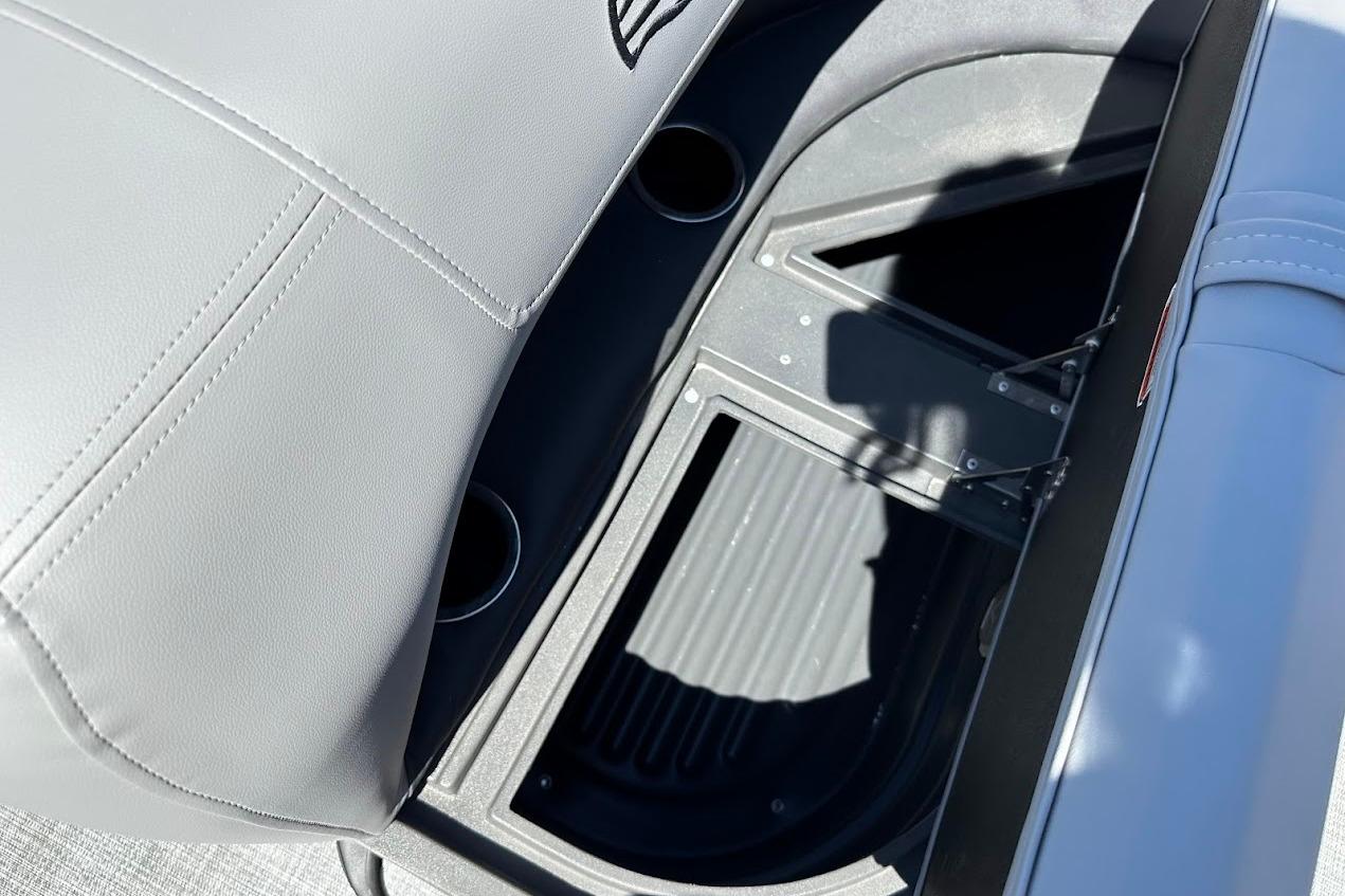 Sun Tracker Party Barge 18 DLX 2026 interior storage compartment with cup holders.