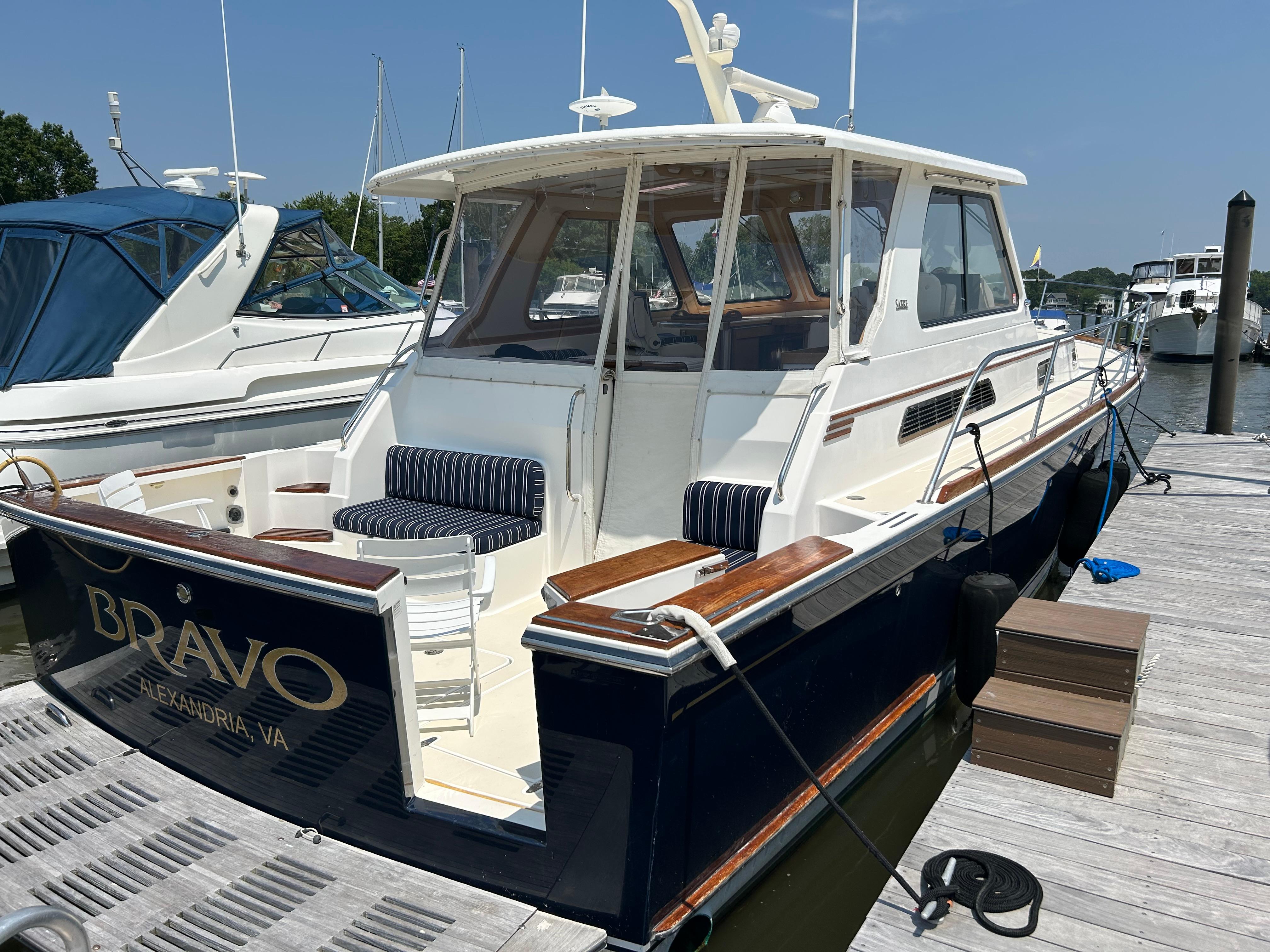 2005 Sabre 42 Hardtop Express yacht docked, featuring elegant design and spacious seating.