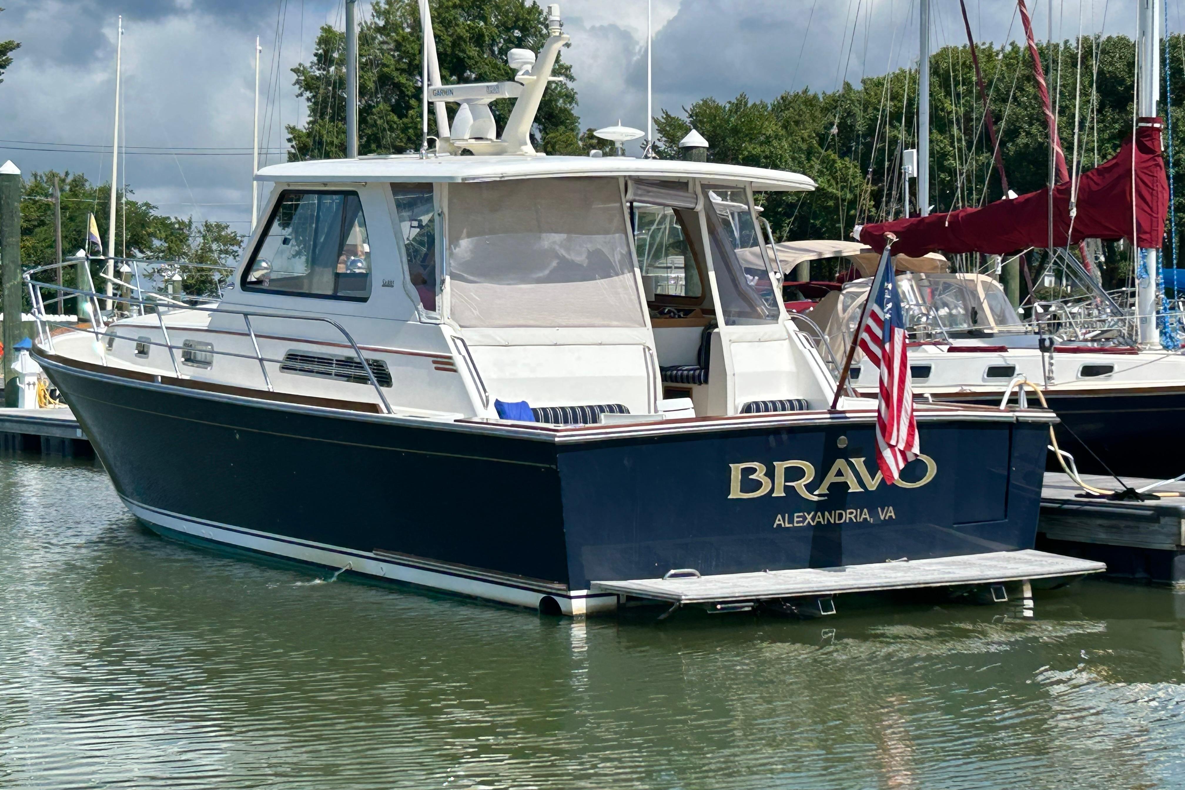 2005 Sabre 42 Hardtop Express boat docked, displaying u0022Bravou0022 and American flag.
