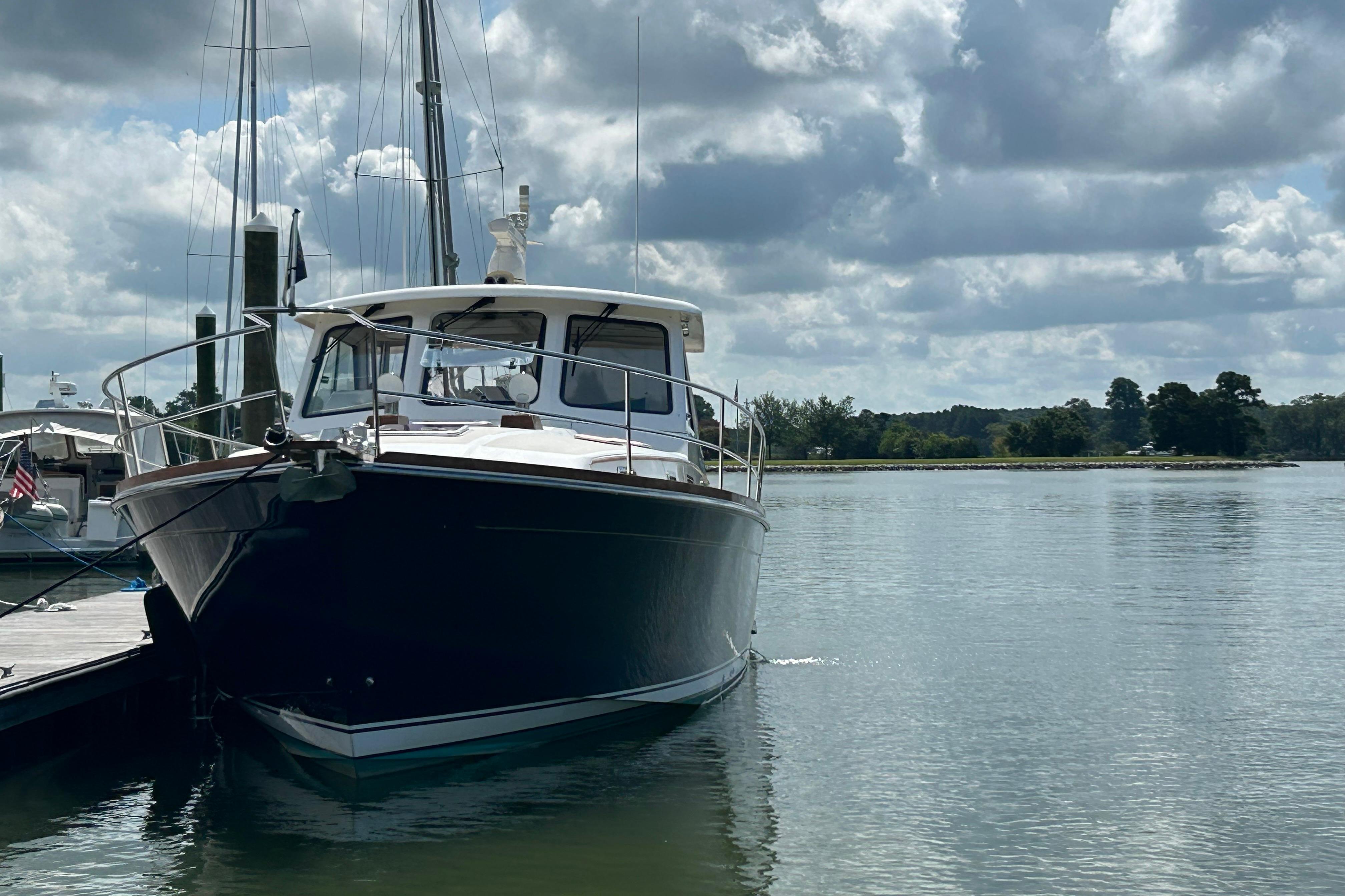 2005 Sabre 42 Hardtop Express yacht docked on a calm, scenic waterway.