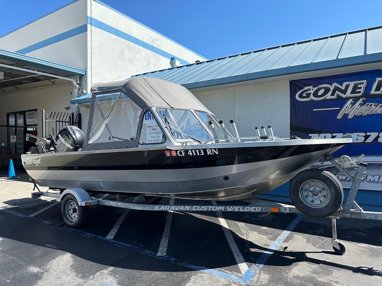 2008 Jetcraft 1925 Adventurer boat on trailer, parked outside a marine shop.