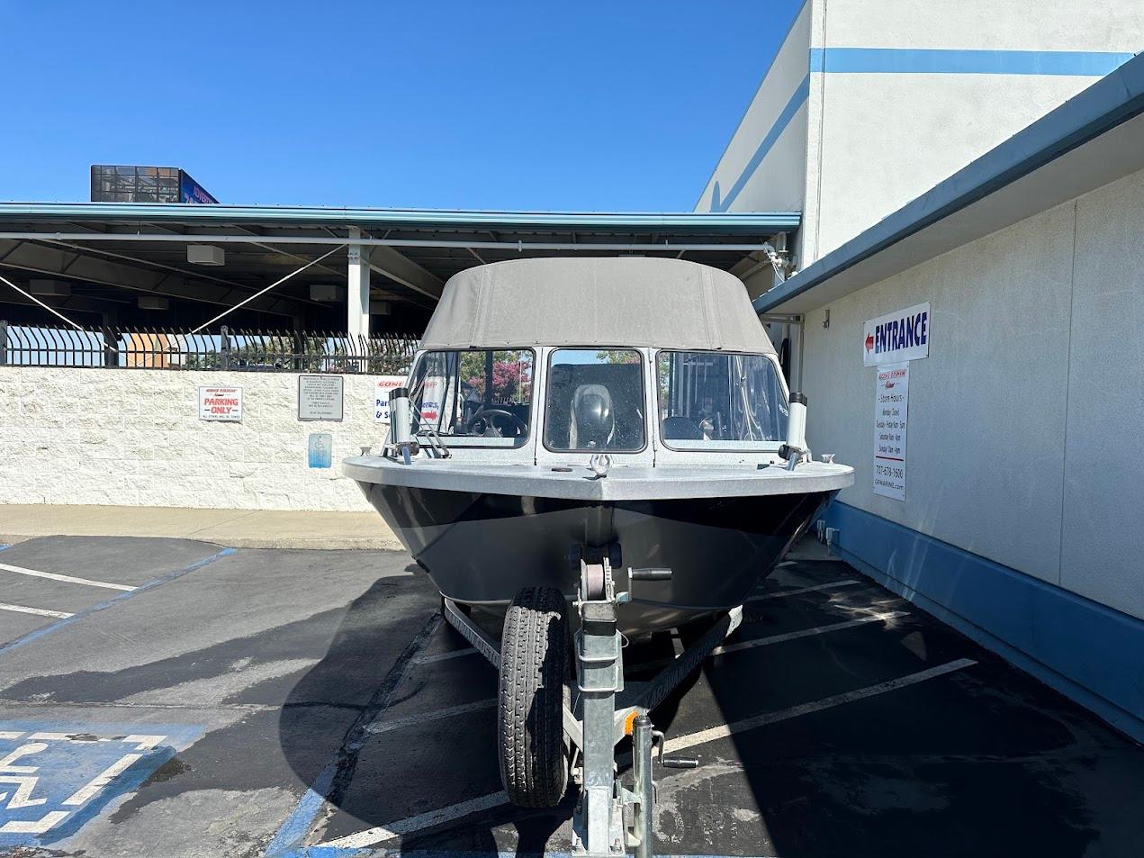Jetcraft 1925 Adventurer boat, 2008 model, parked outside a building on a sunny day.
