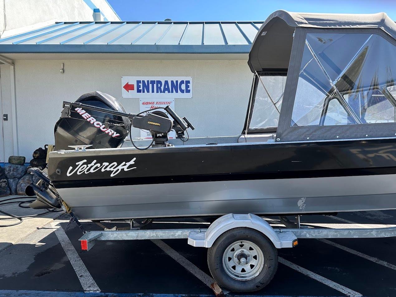 Jetcraft 1925 Adventurer boat, 2008 model, on trailer near entrance sign.