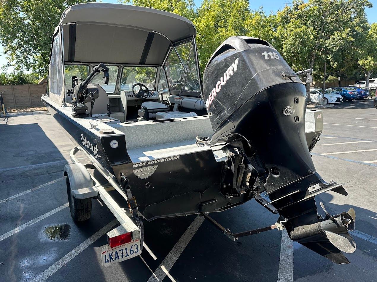 2008 Jetcraft 1925 Adventurer boat with Mercury 115 engine in a parking lot.