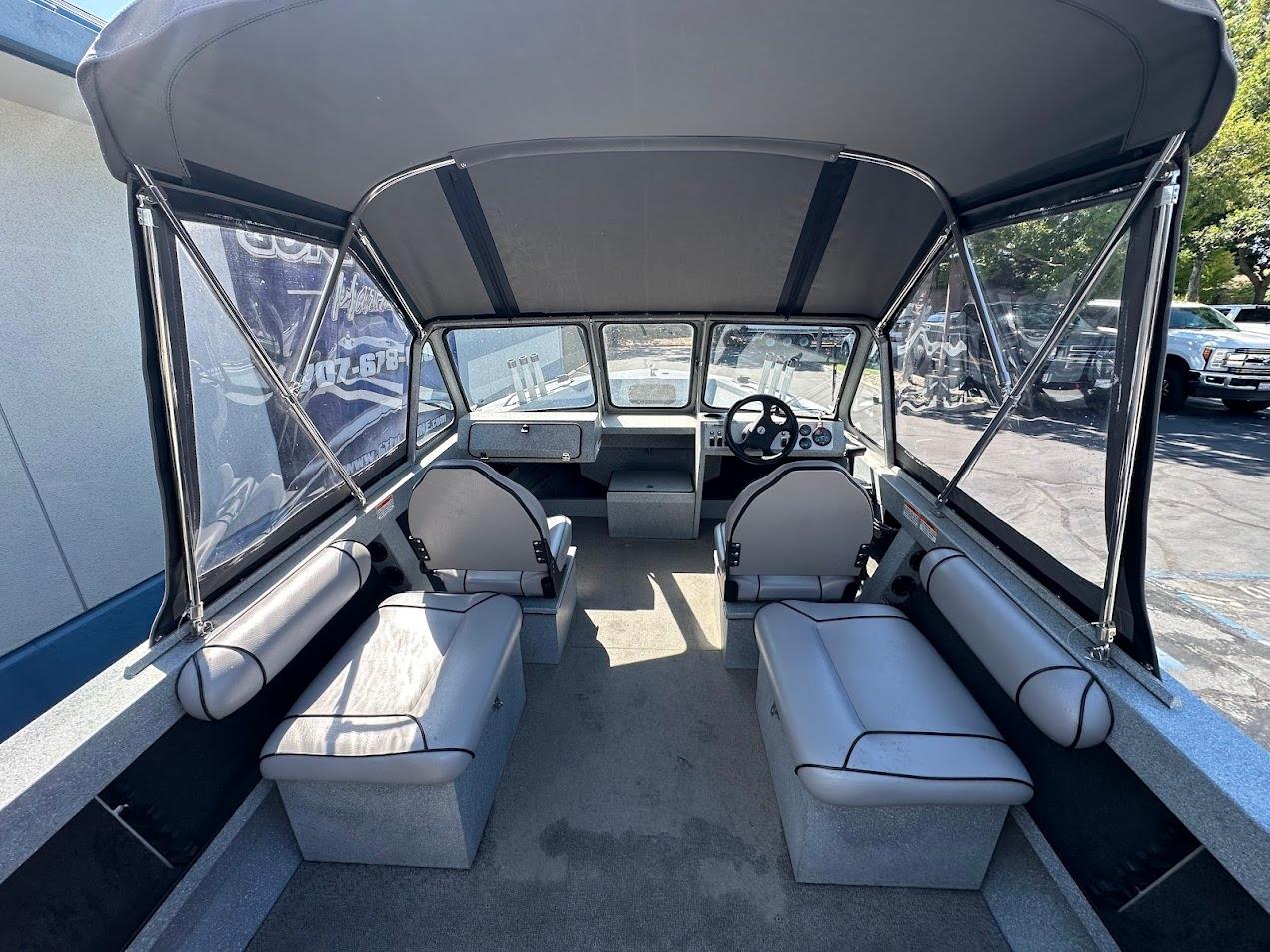 Interior of 2008 Jetcraft 1925 Adventurer boat with seating and steering wheel.
