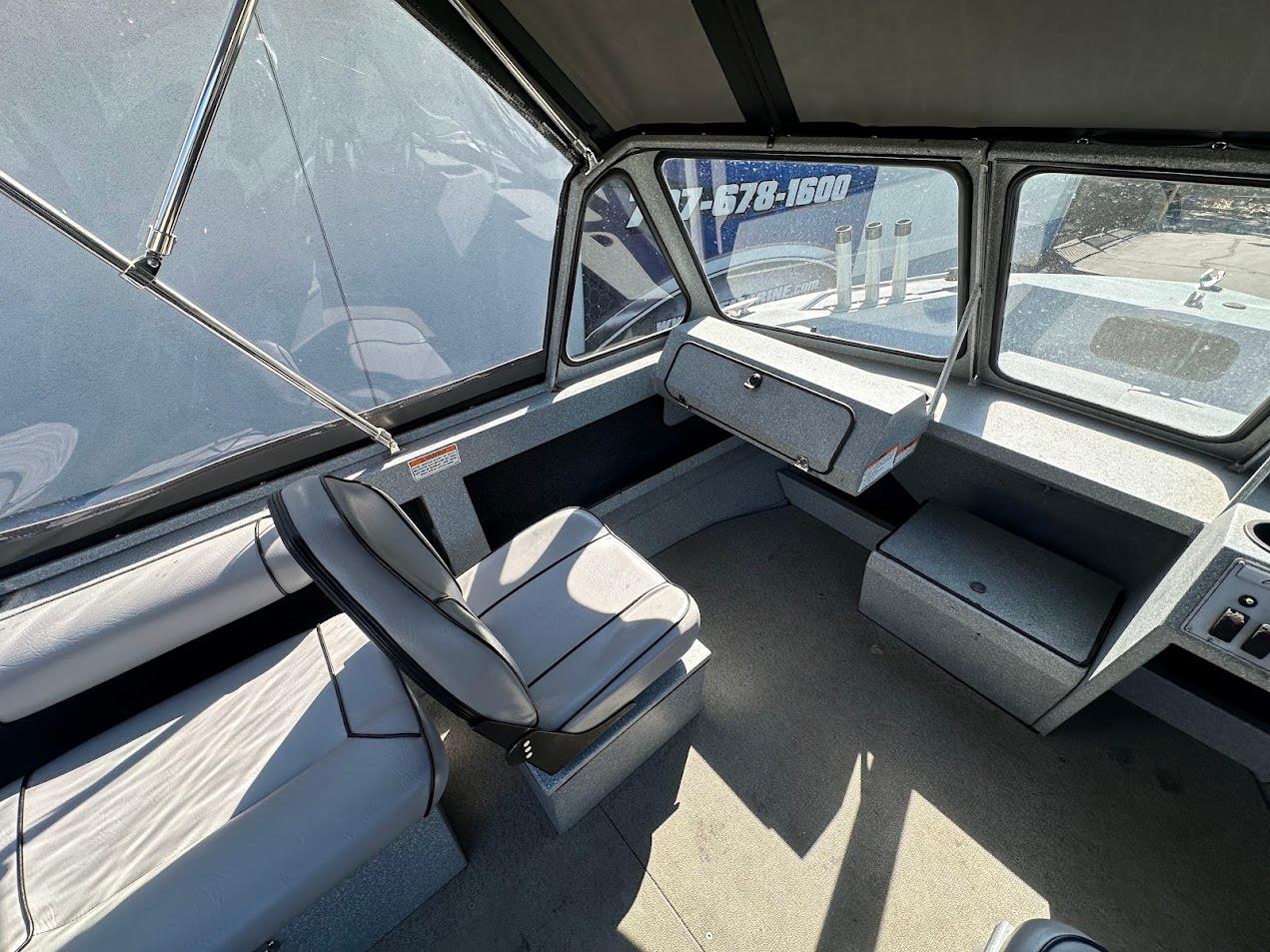 Interior of a 2008 Jetcraft 1925 Adventurer boat, featuring seating and dashboard.