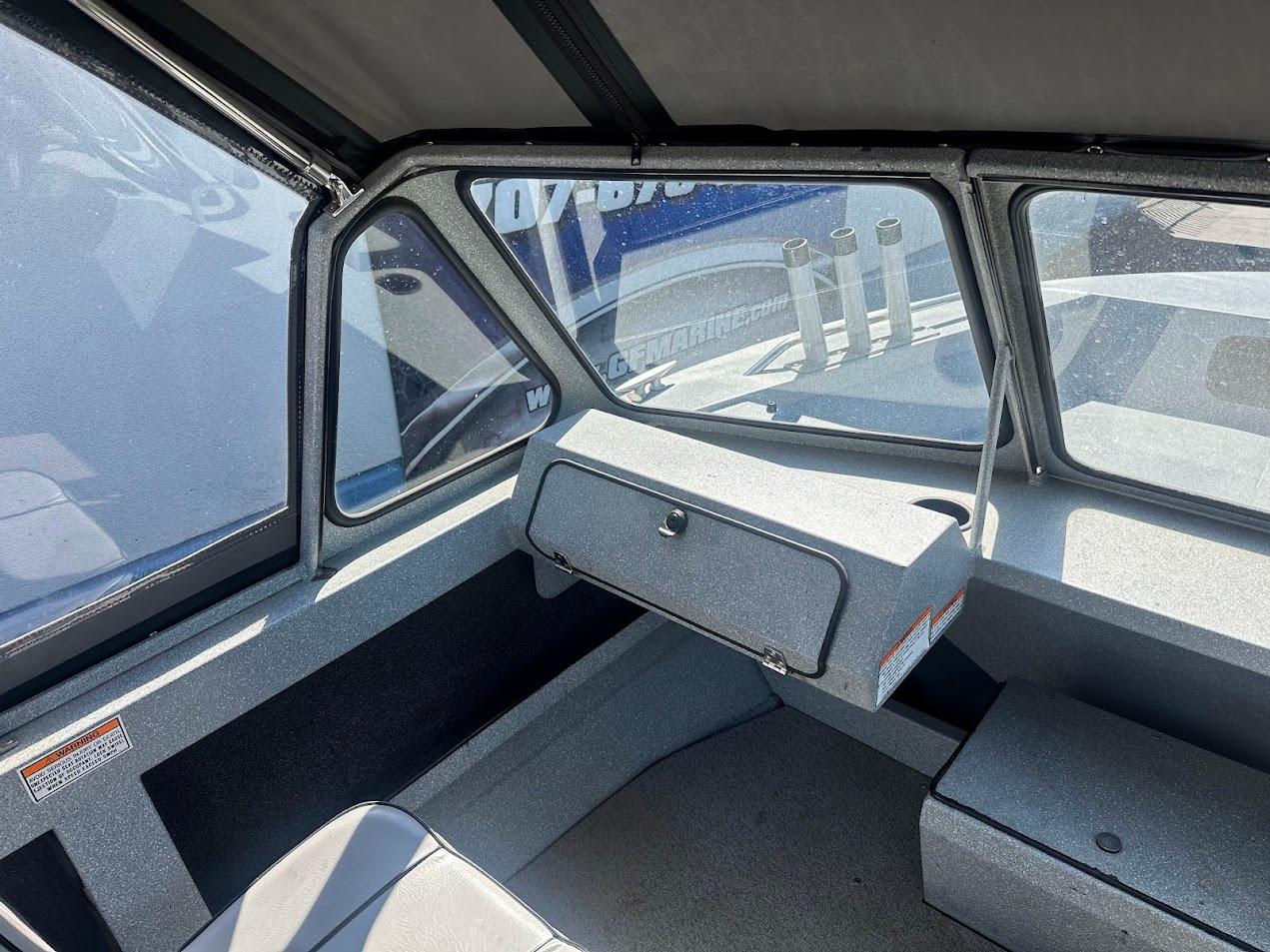 Interior of a 2008 Jetcraft 1925 Adventurer boat, featuring seating and dashboard.