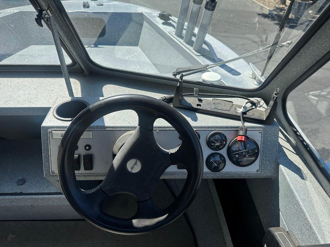 Jetcraft 1925 Adventurer 2008 boat dashboard with steering wheel and gauges.