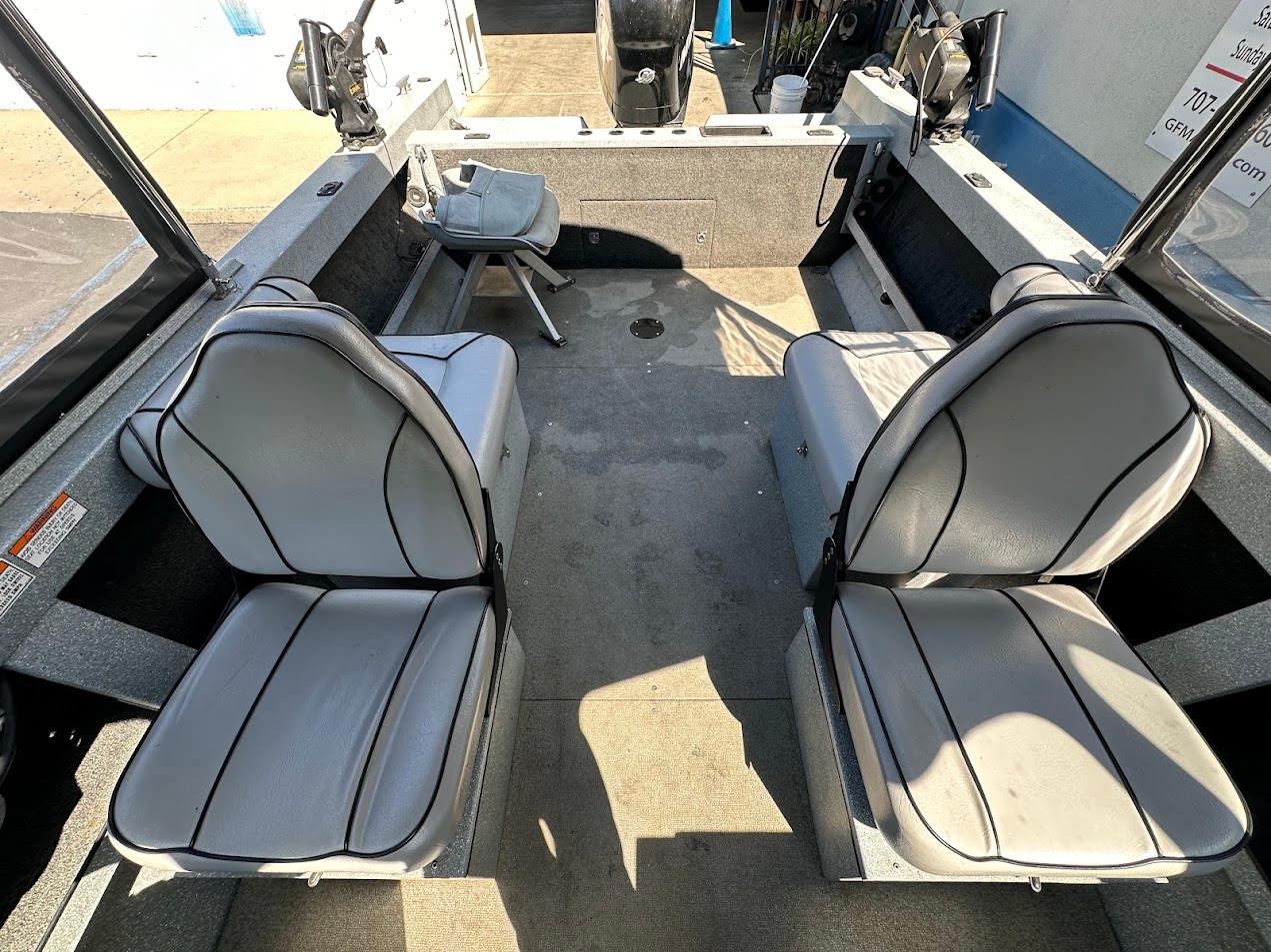 Interior of a 2008 Jetcraft 1925 Adventurer boat with gray seating and fishing equipment.