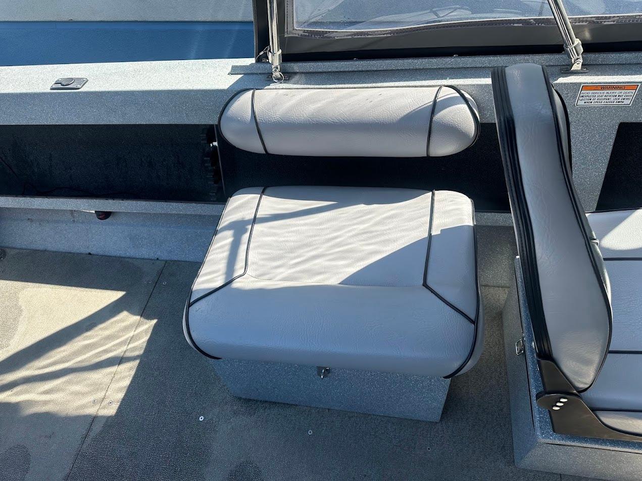 Jetcraft 1925 Adventurer 2008 boat interior with gray seating and storage compartment.