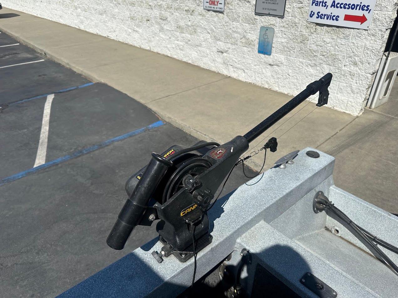 Boat-mounted fishing downrigger on a 2008 Jetcraft 1925 Adventurer, parked near a service center.