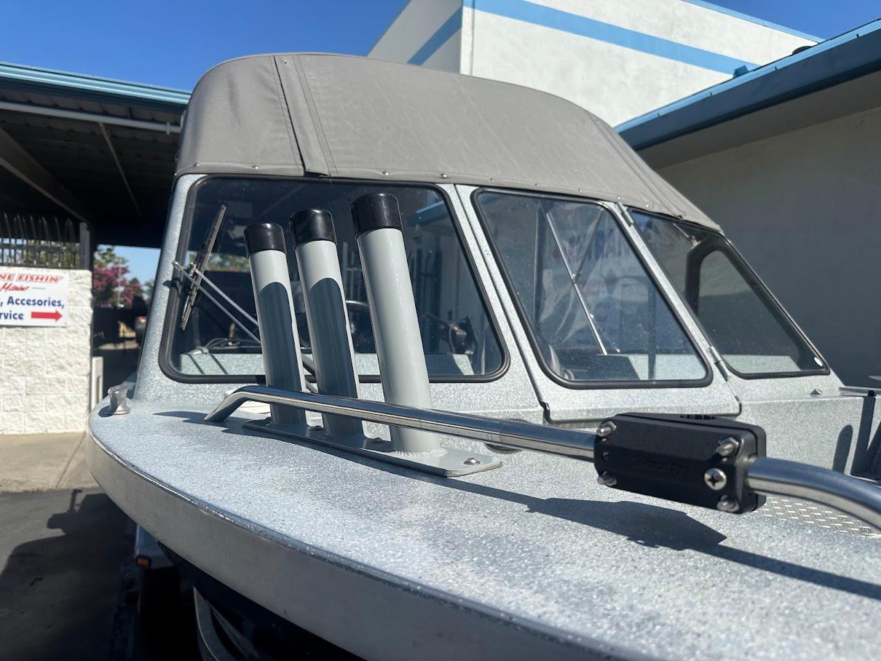 2008 Jetcraft 1925 Adventurer boat with canopy and rod holders, parked outdoors.